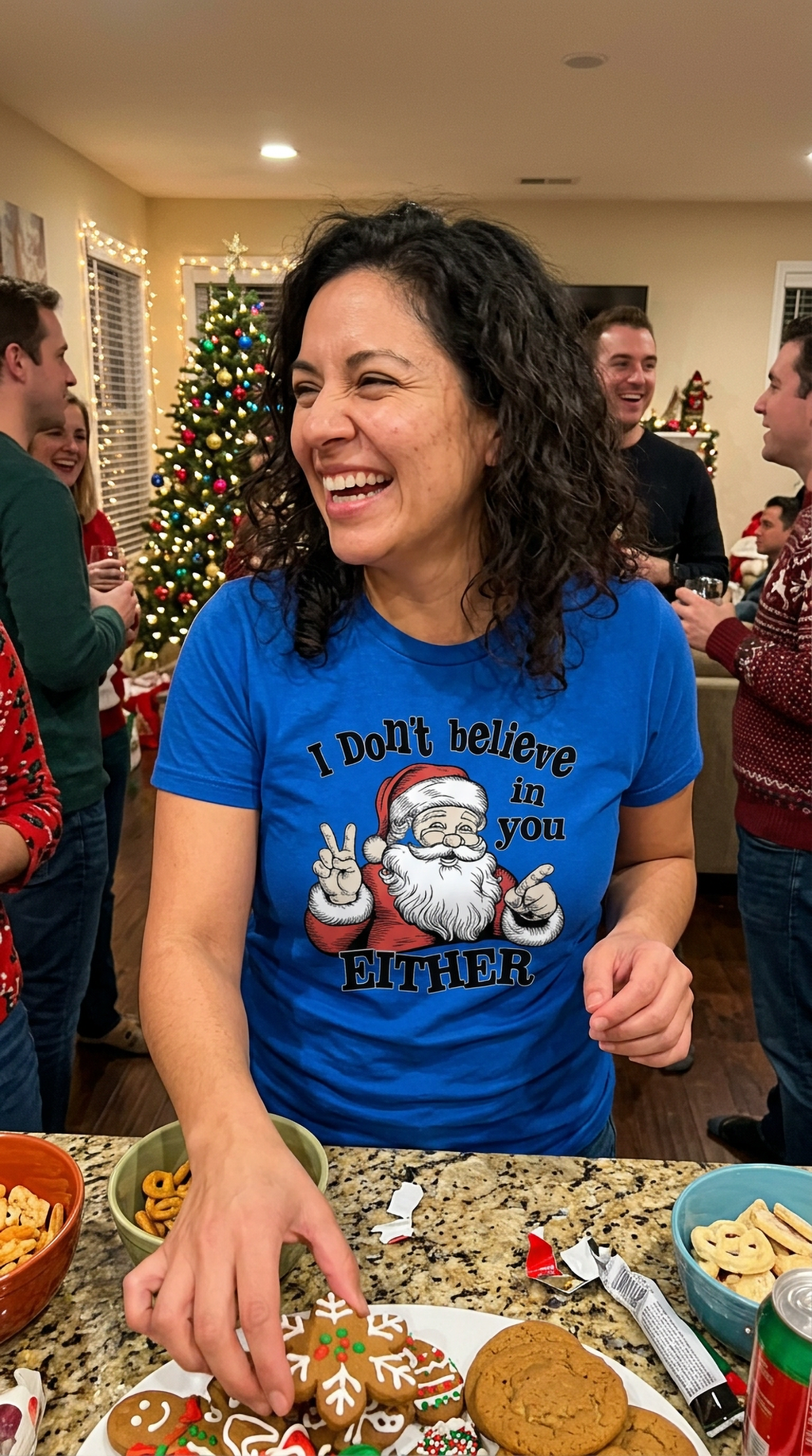 Woman wearing a blue sarcastic Santa Christmas shirt while celebrating with friends at a holiday party.