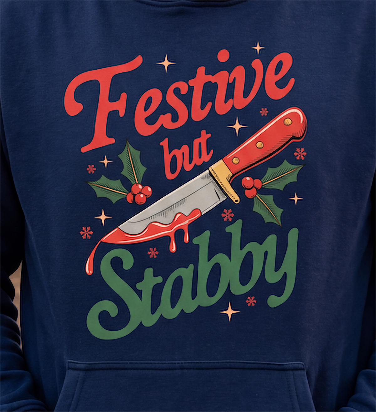 Close-up of navy blue dark humor Christmas hoodie with festive knife graphic