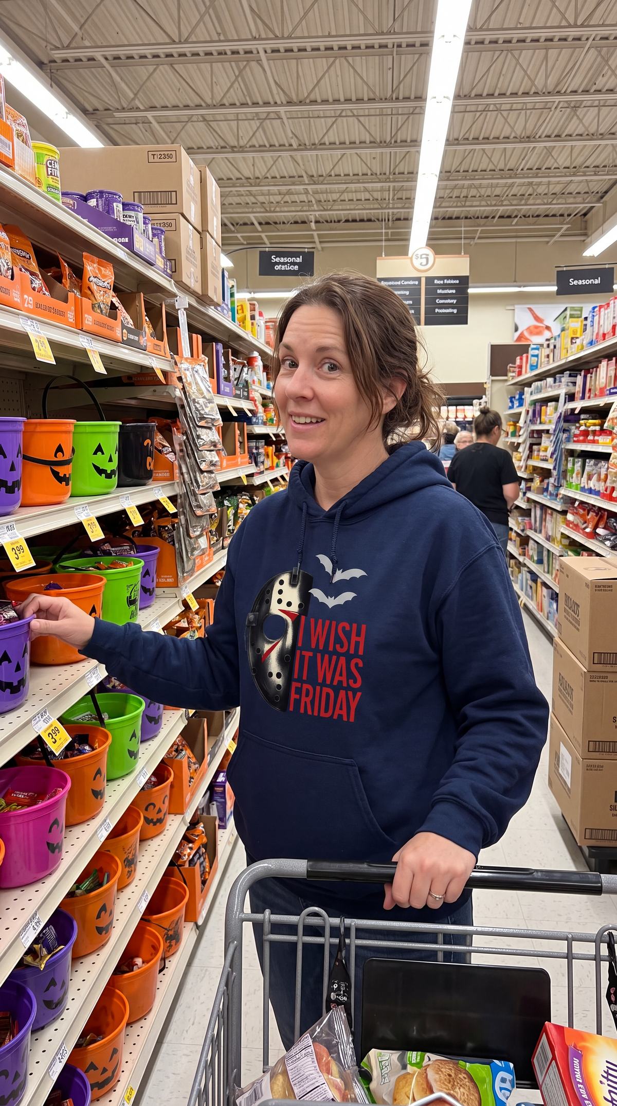 Woman wearing navy Friday the 13th Jason Voorhees horror hoodie in store
