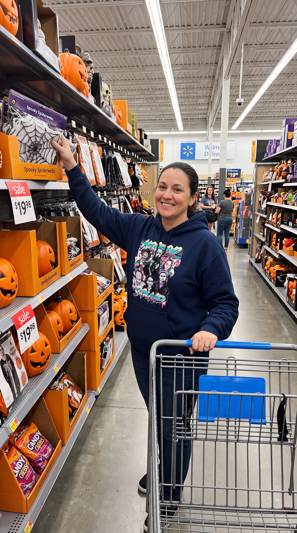 Woman wearing navy Horror Squad hoodie with retro horror movie character graphic