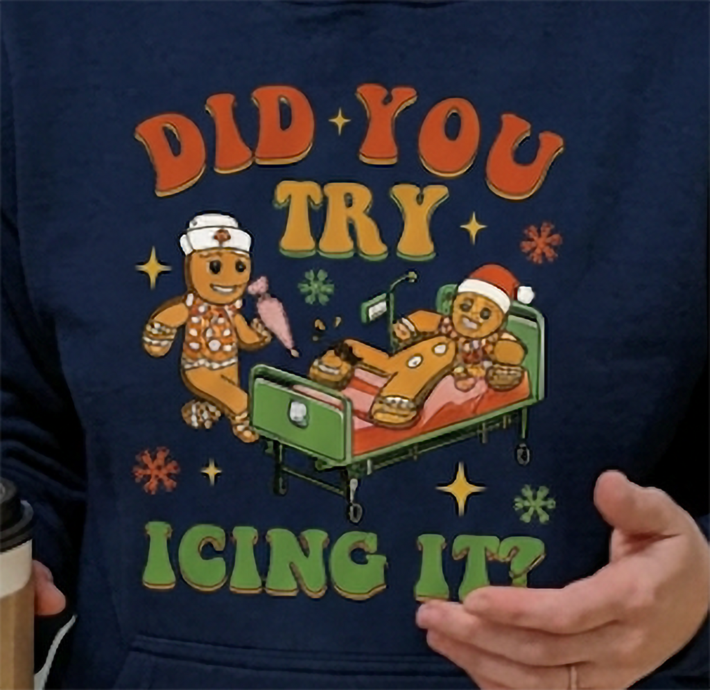 Close-up of Did You Try Icing It gingerbread graphic on navy blue Christmas hoodie