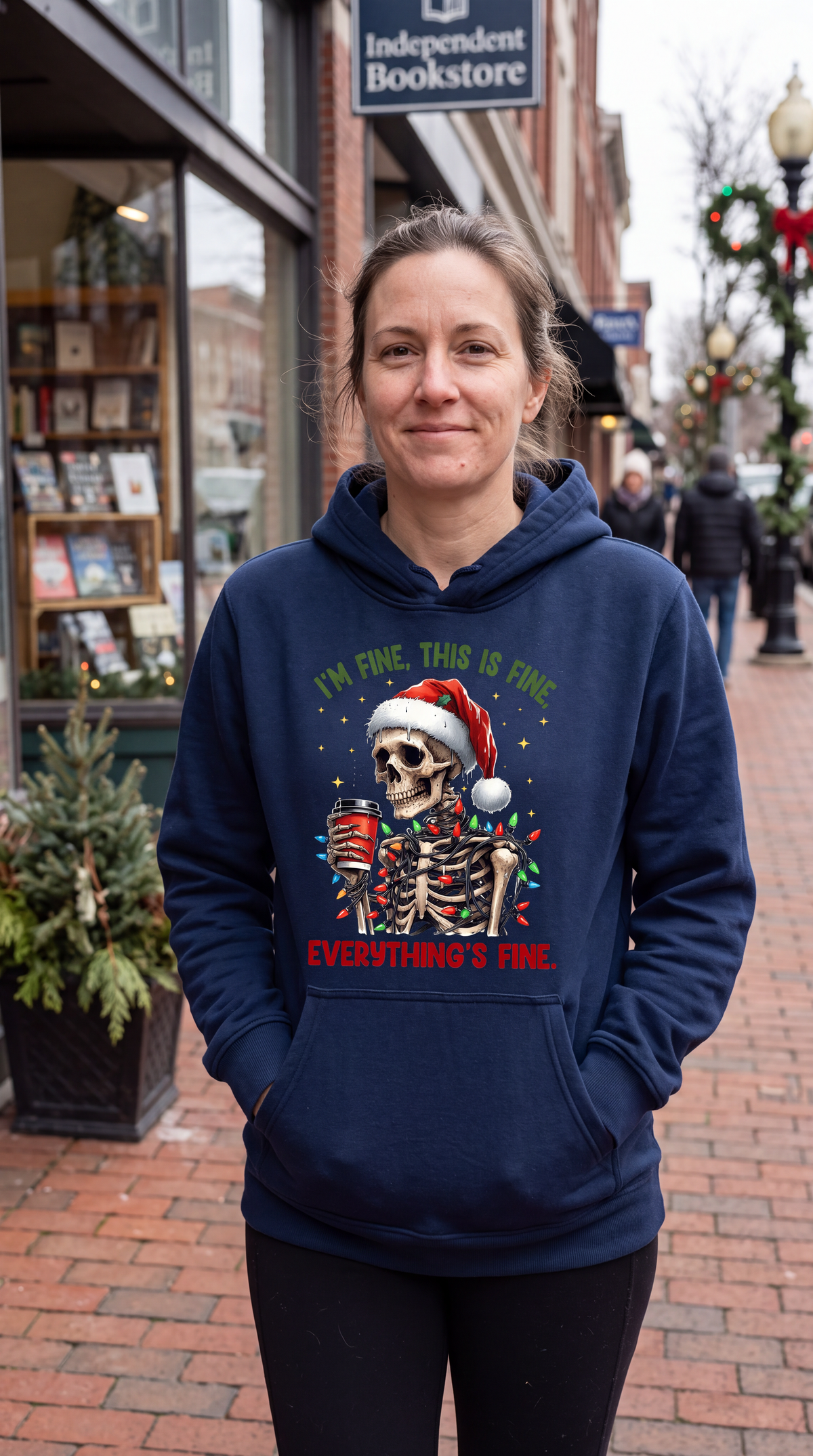 Woman wearing navy blue Christmas skeleton hoodie with sarcastic holiday design