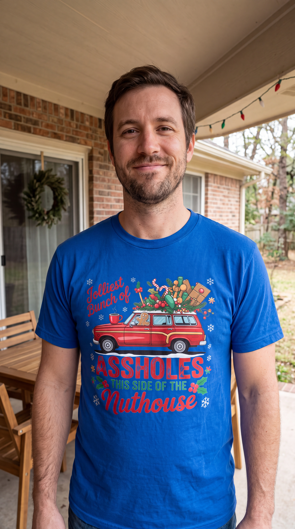 Man wearing blue Jolliest Bunch of Assholes funny Christmas graphic shirt.