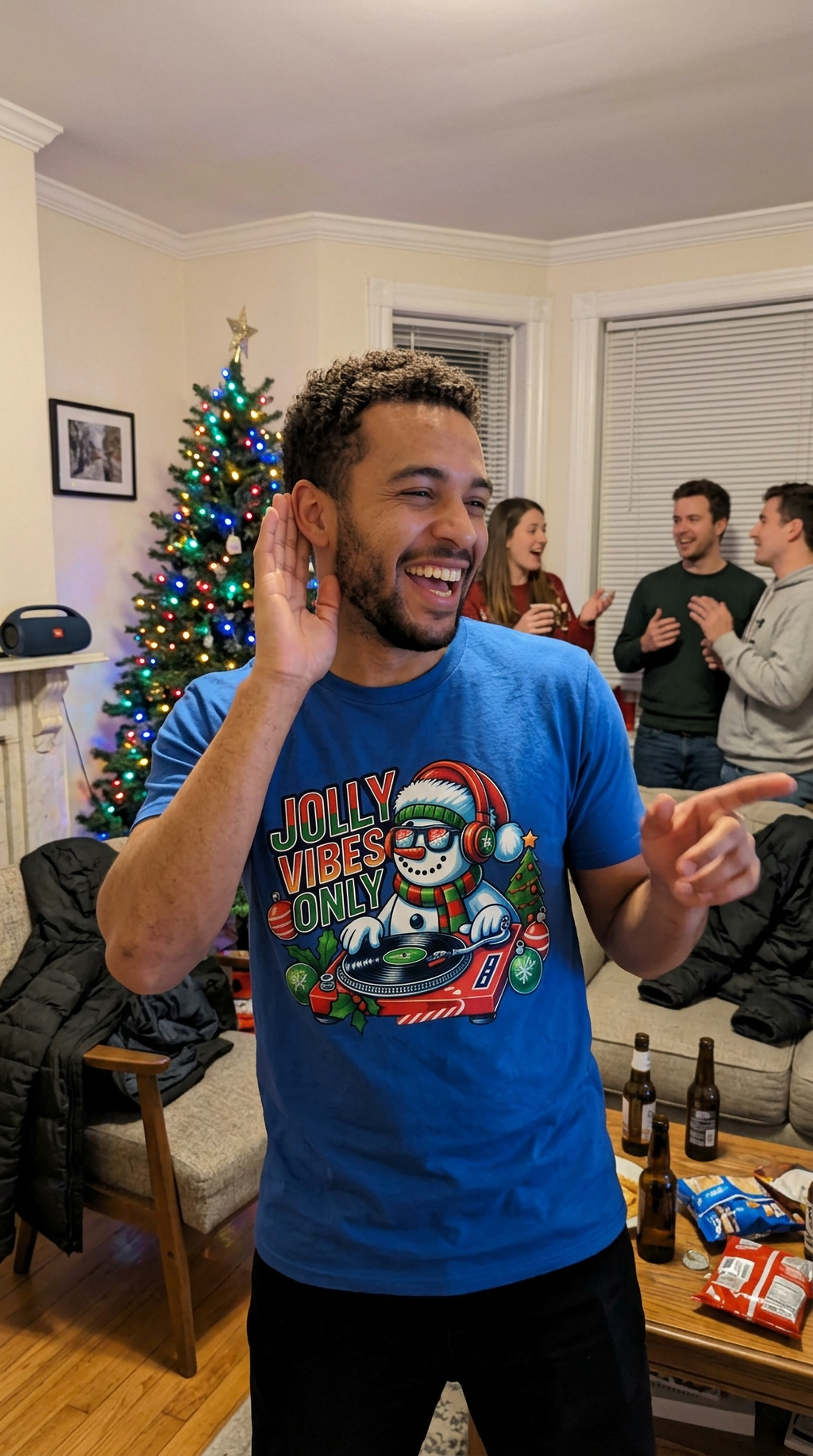 Blue Lifestyle: Person wearing a blue Jolly Vibes Only Christmas t-shirt featuring a festive snowman DJ graphic.