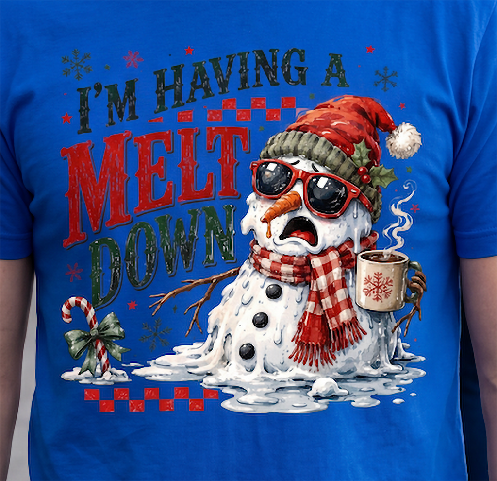 Close-up of blue I’m Having a Meltdown Christmas shirt with distressed holiday lettering and melting snowman artwork.