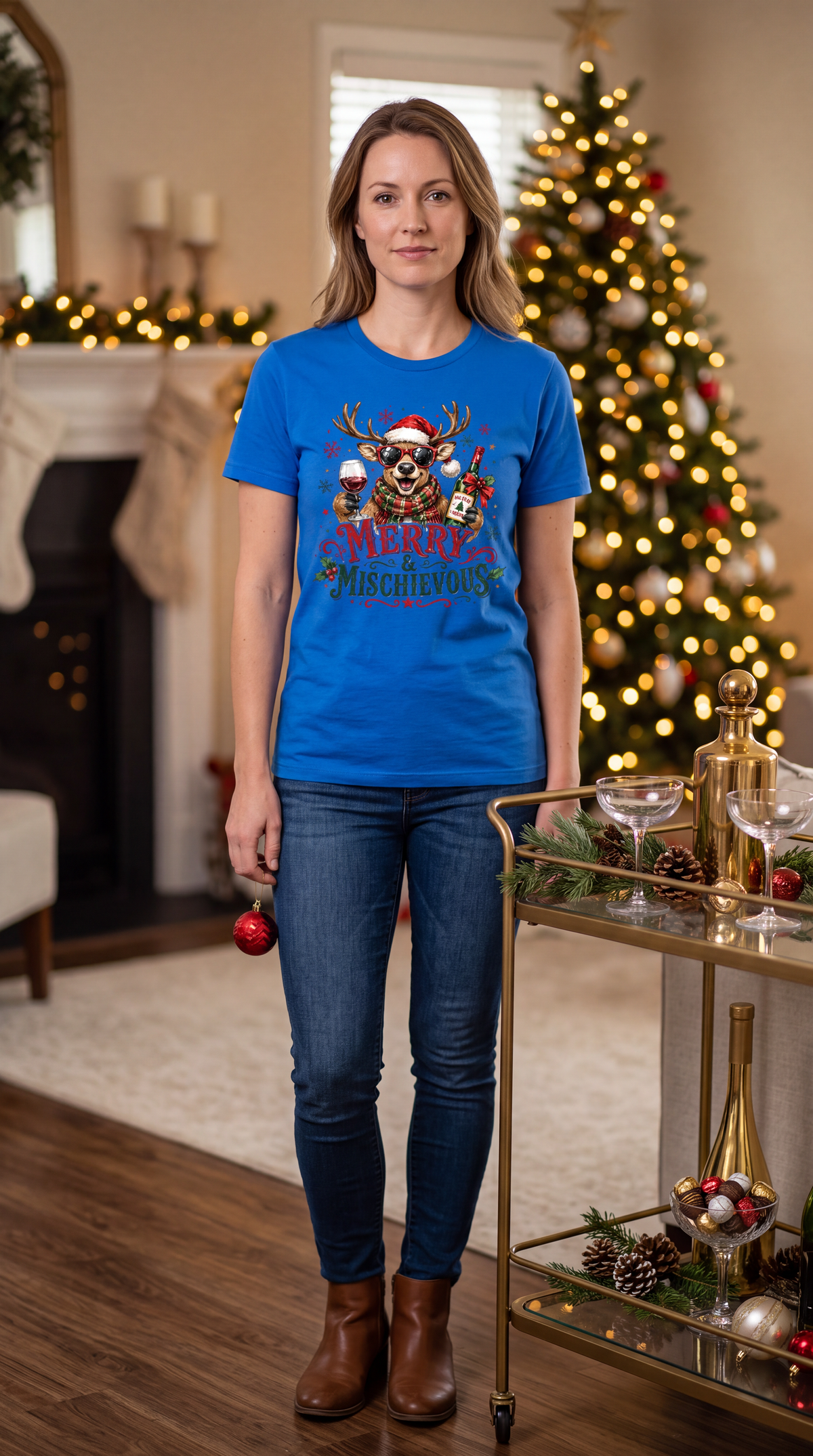 Woman wearing royal blue Merry & Mischievous Christmas shirt with reindeer wine graphic.
