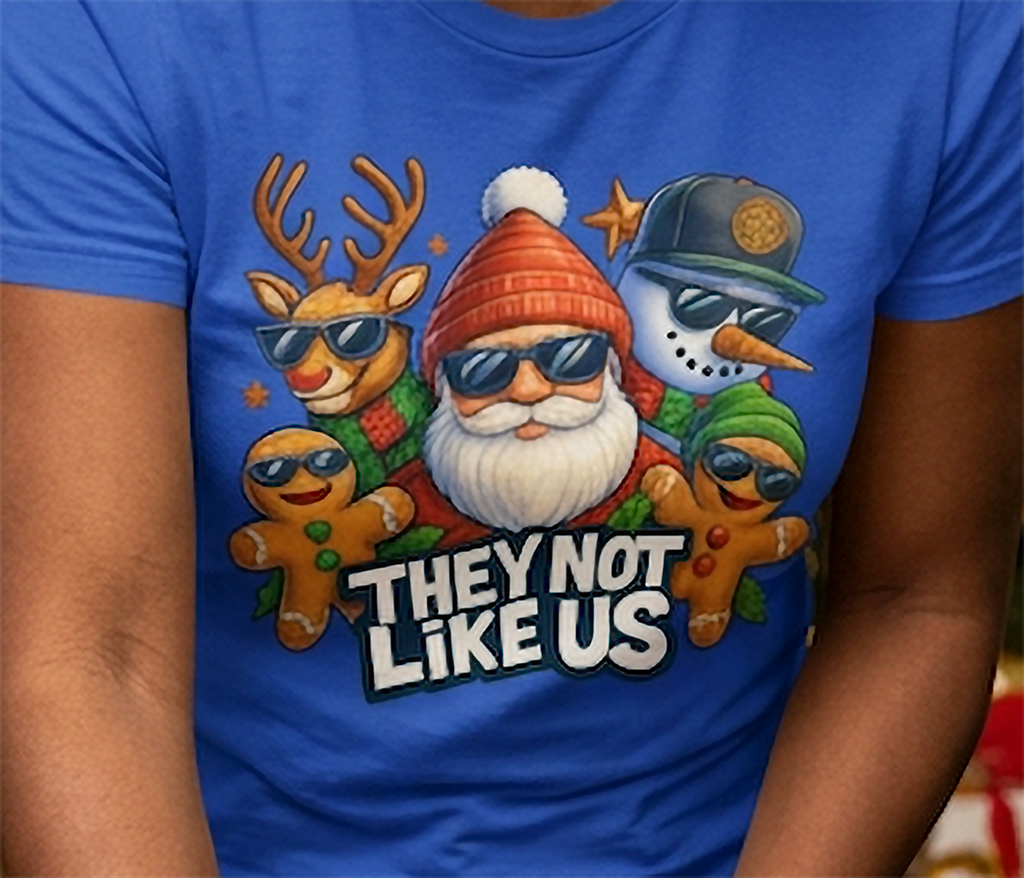 Blue Close-Up: Close-up of They Not Like Us Christmas artwork printed on a blue t-shirt featuring festive characters wearing sunglasses.