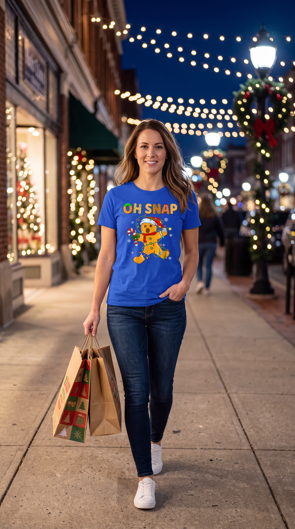 Person wearing blue Oh Snap gingerbread Christmas graphic T-shirt.