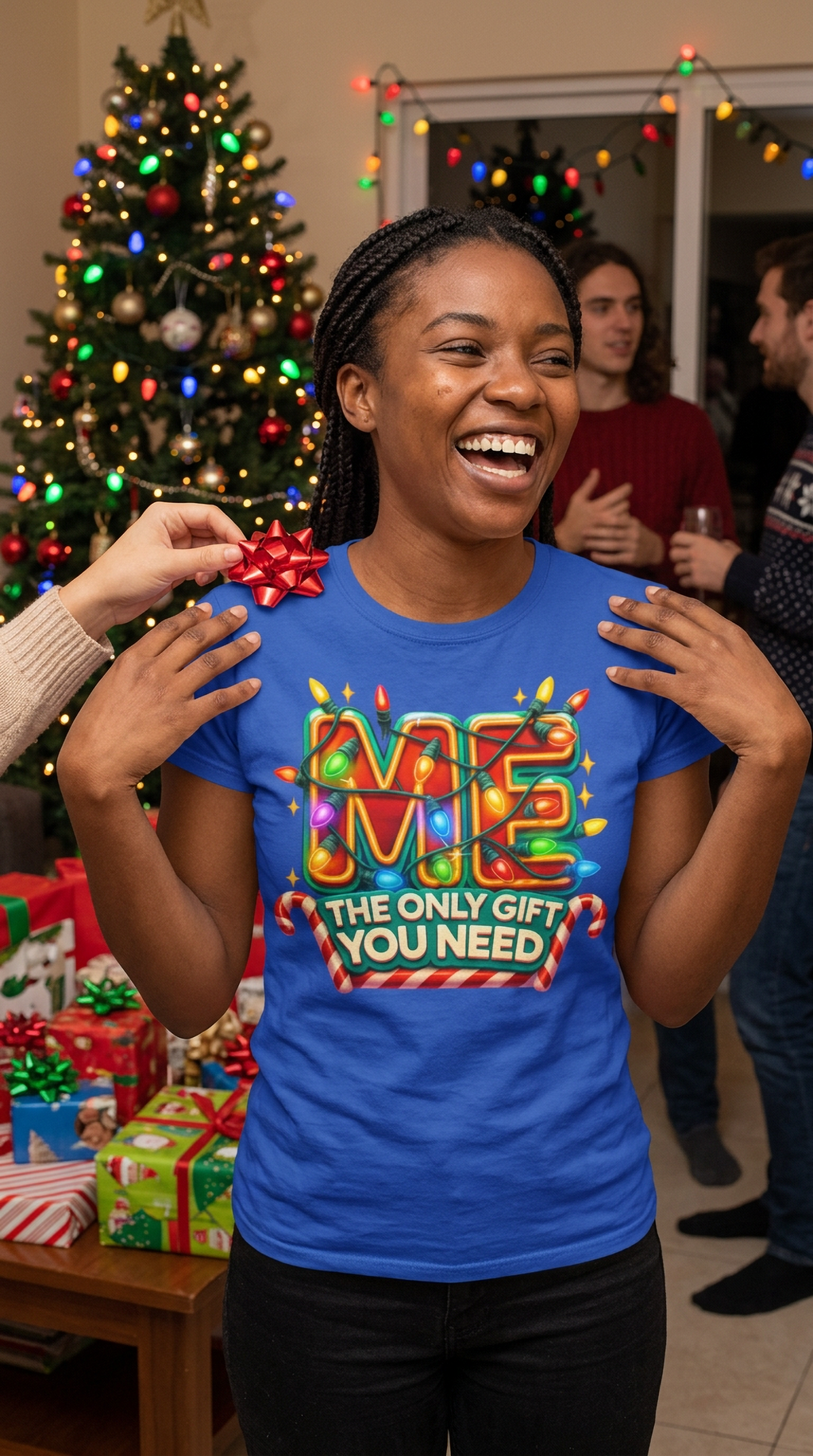 Lifestyle – Blue: Man wearing a blue Christmas graphic t-shirt with colorful holiday lettering at a festive Christmas gathering.