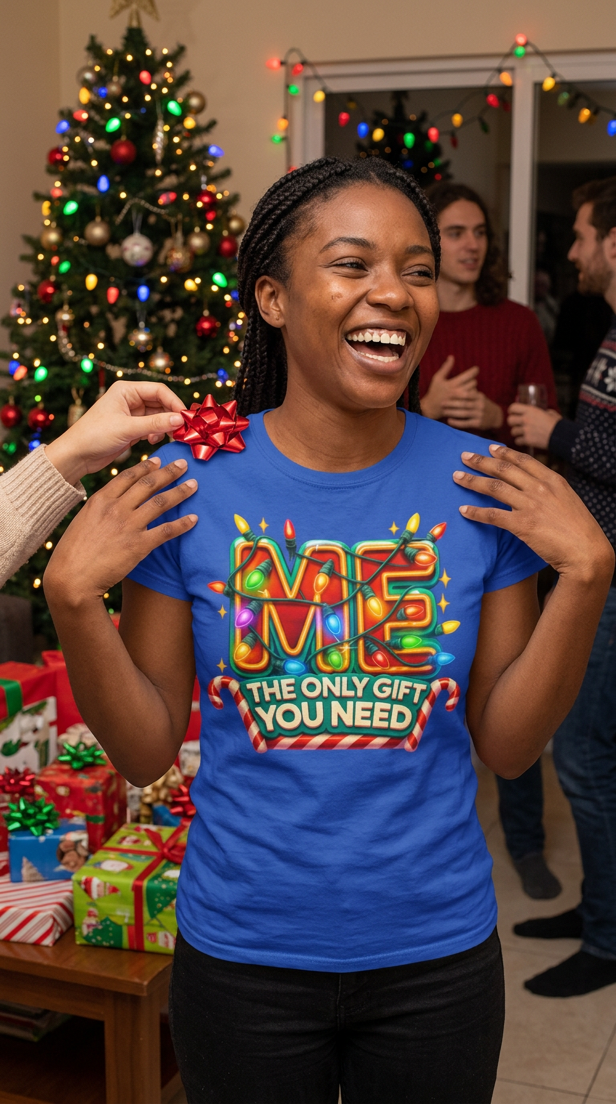Lifestyle – Blue: Man wearing a blue Christmas graphic t-shirt with colorful holiday lettering at a festive Christmas gathering.