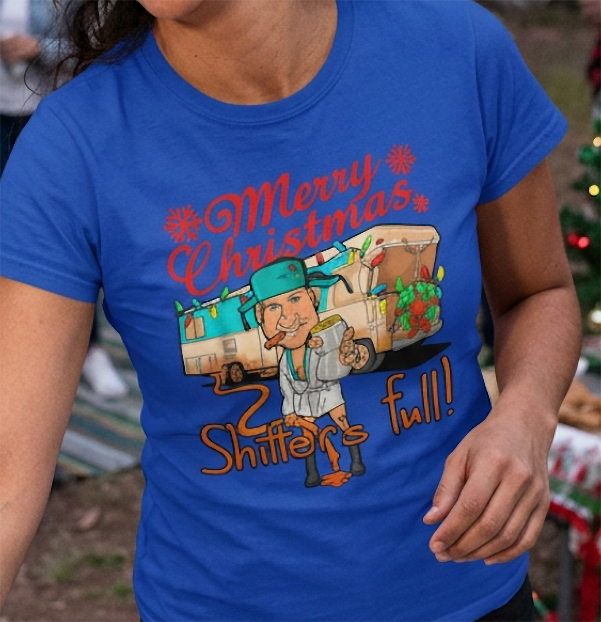 Blue Design Close-Up: Close-up of blue Christmas t-shirt featuring festive camper artwork, holiday decorations, and funny Christmas graphic.