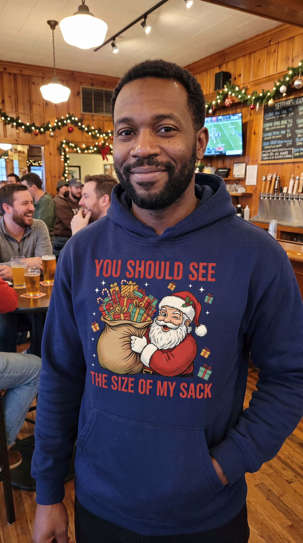 Man wearing navy blue funny Santa Christmas hoodie with adult Christmas humor design