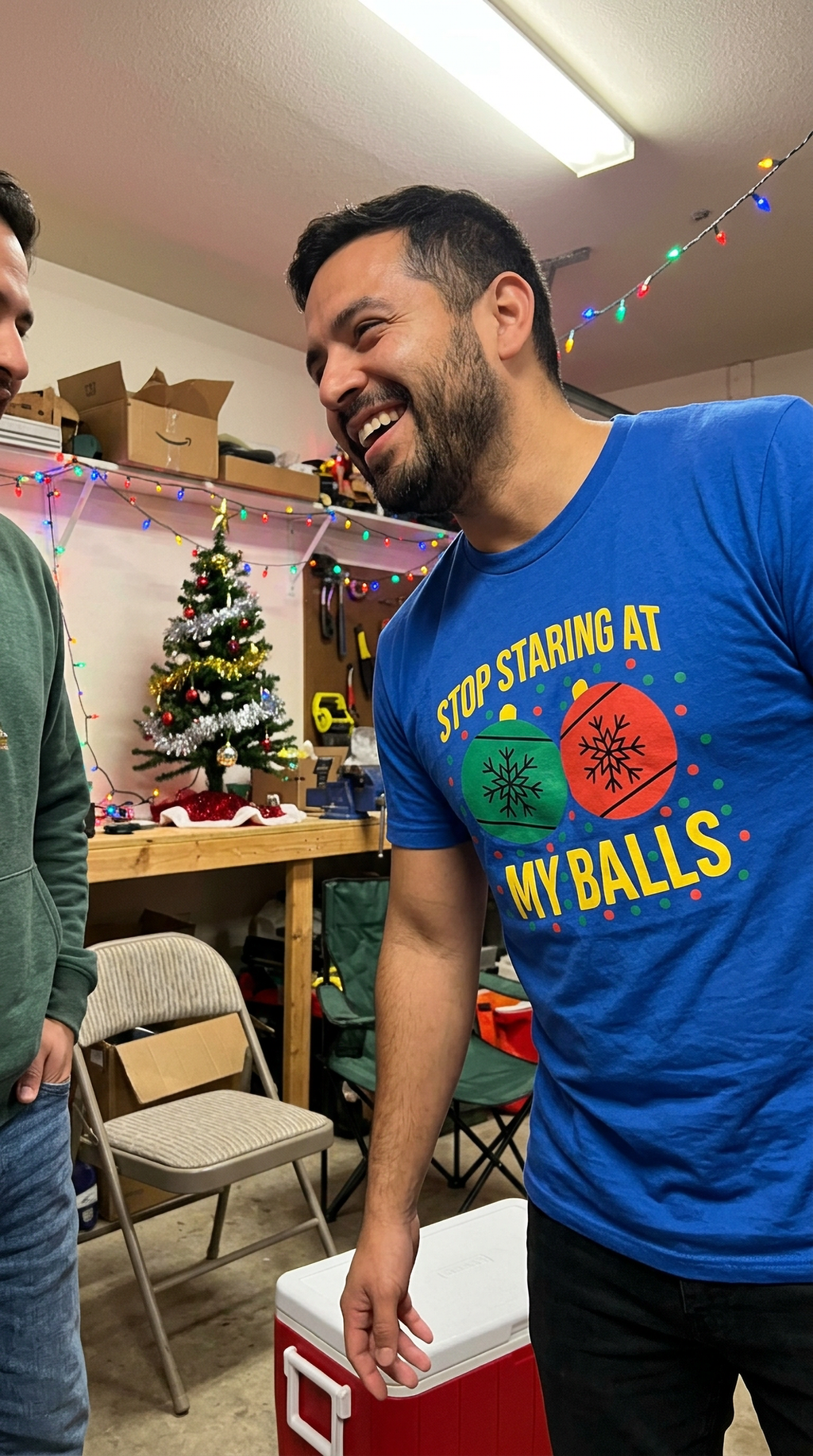 Man wearing blue Stop Staring at My Balls Christmas t-shirt while celebrating the holiday season.