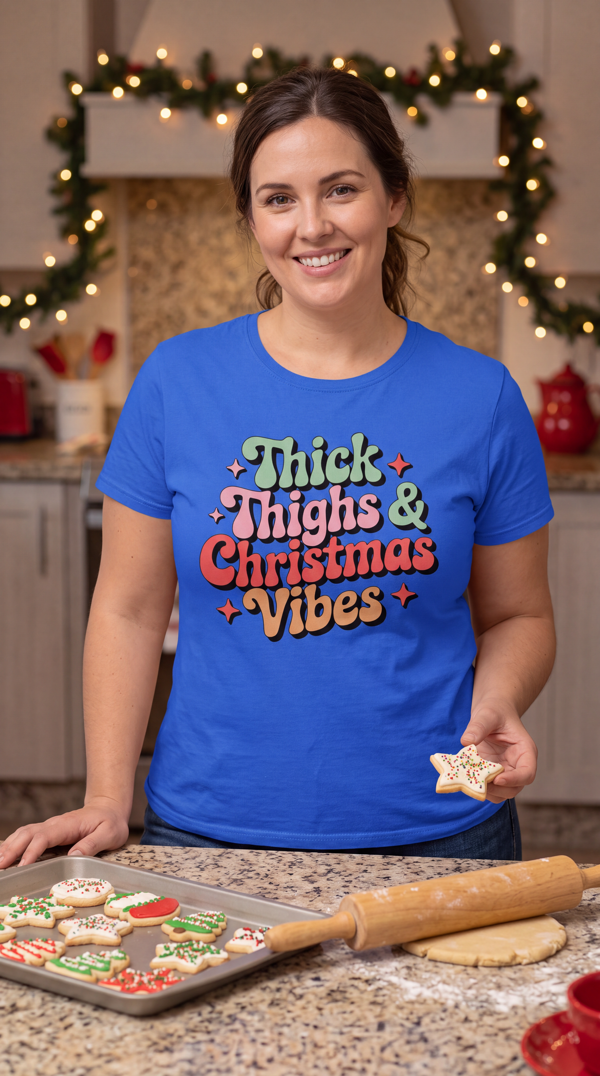Woman wearing blue Thick Thighs & Christmas Vibes Christmas shirt in a festive holiday setting.