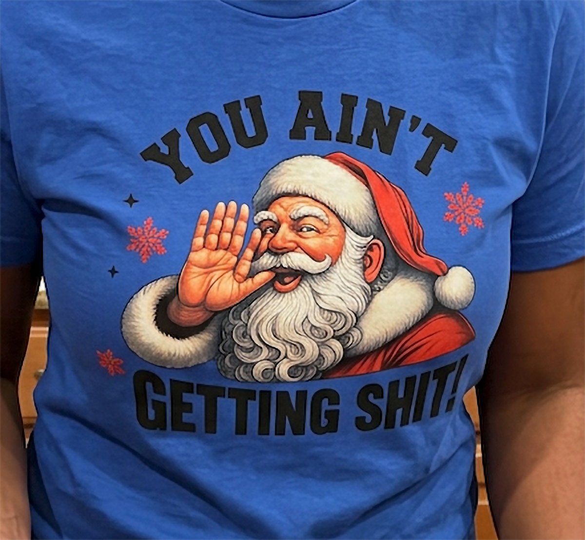 Blue Close-Up: Detailed close-up of vintage Santa Claus Christmas artwork and sarcastic holiday lettering printed on blue fabric.