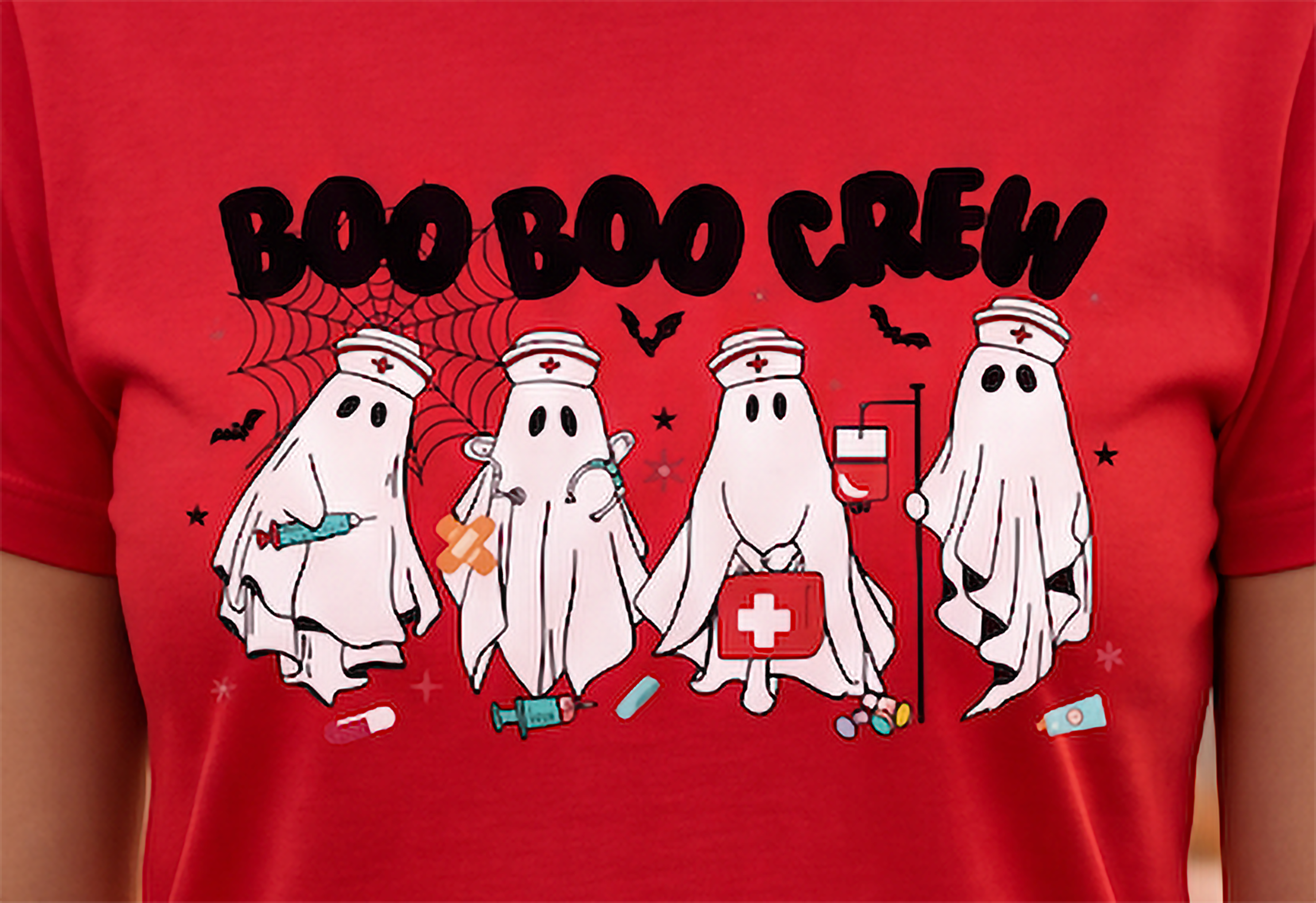 Close-up of Boo Boo Crew nurse Halloween graphic featuring four ghost nurses, syringes, medical bag, IV stand, bats and spiderweb.