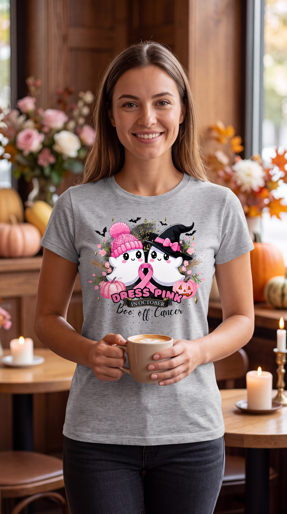 Woman wearing a heather gray breast cancer Halloween shirt featuring pink ribbon, cute ghosts, pumpkins and October awareness design.