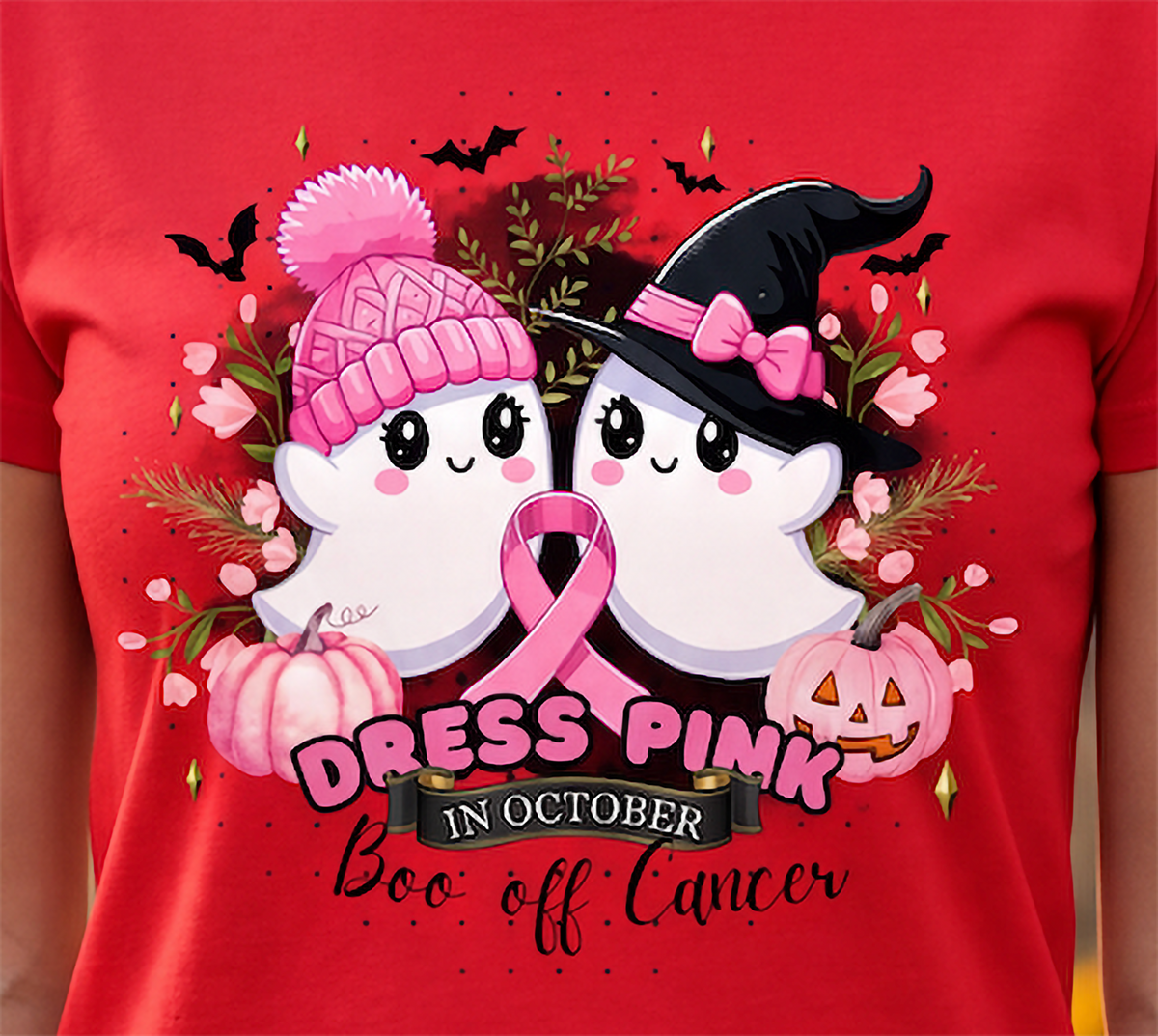 Close-up of breast cancer Halloween design with pink ribbon, cute ghosts, witch hat, pink pumpkins, bats and Boo off Cancer text.