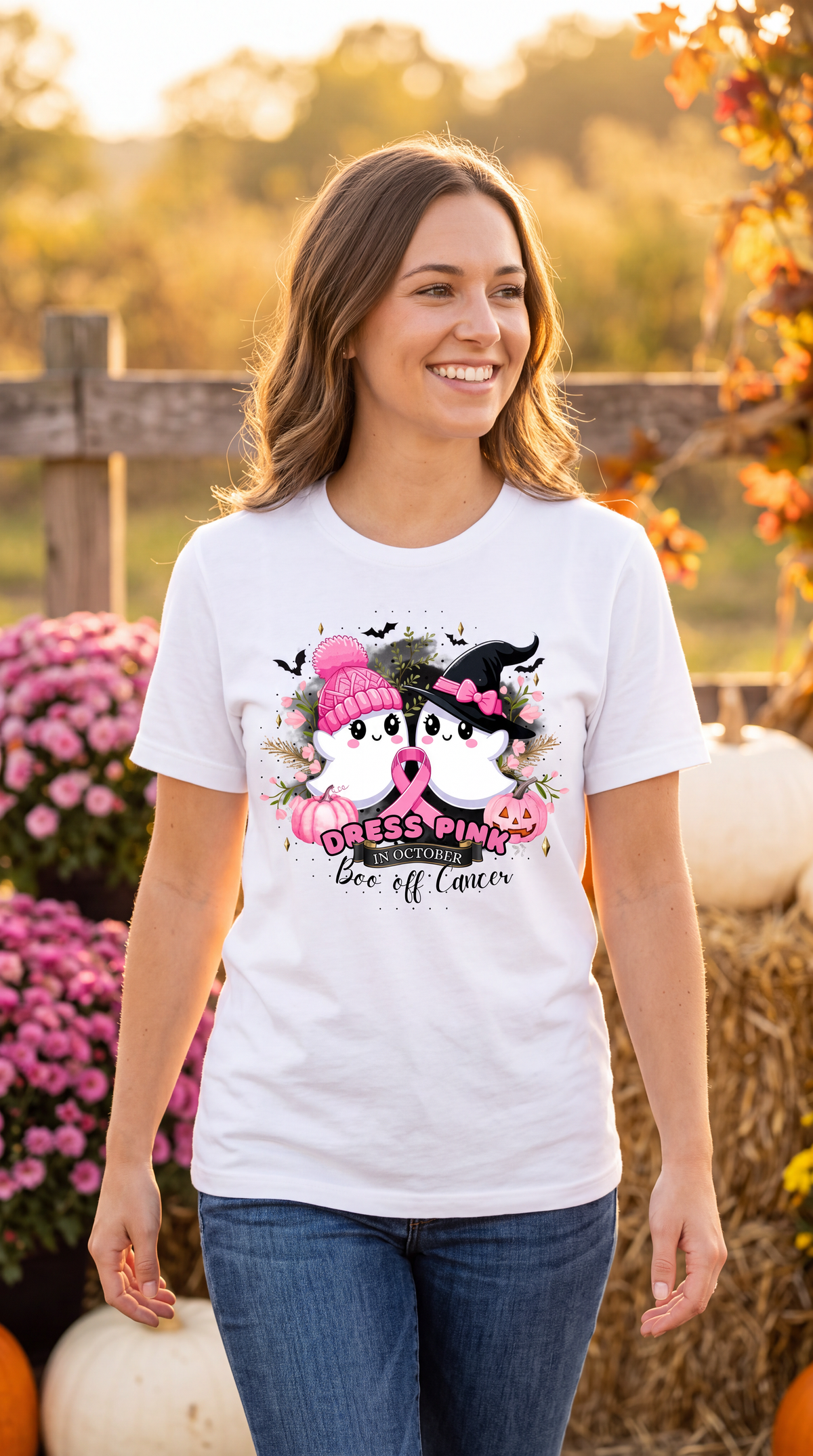 Woman wearing a white breast cancer awareness Halloween shirt featuring pink ribbon, ghosts, pumpkins and Boo off Cancer design.