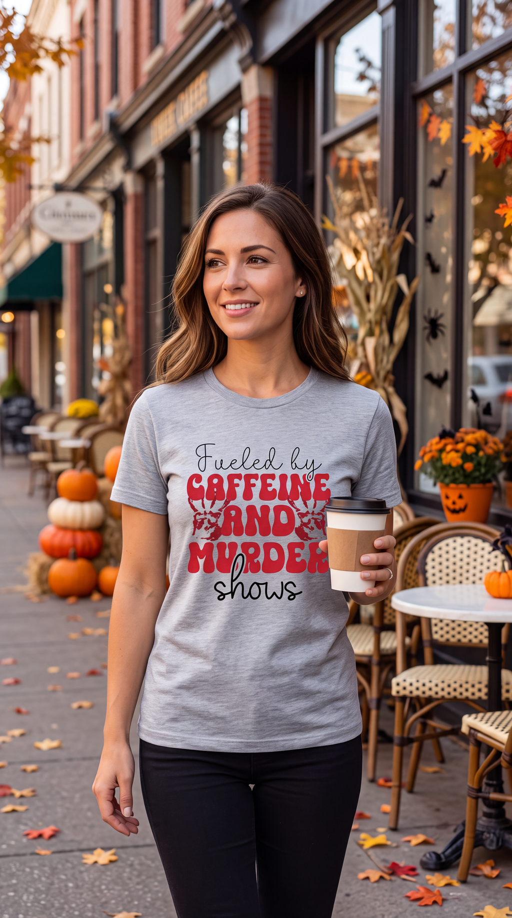 Woman wearing Heather Gray true crime coffee shirt with Caffeine and Murder Shows graphic while holding coffee outdoors