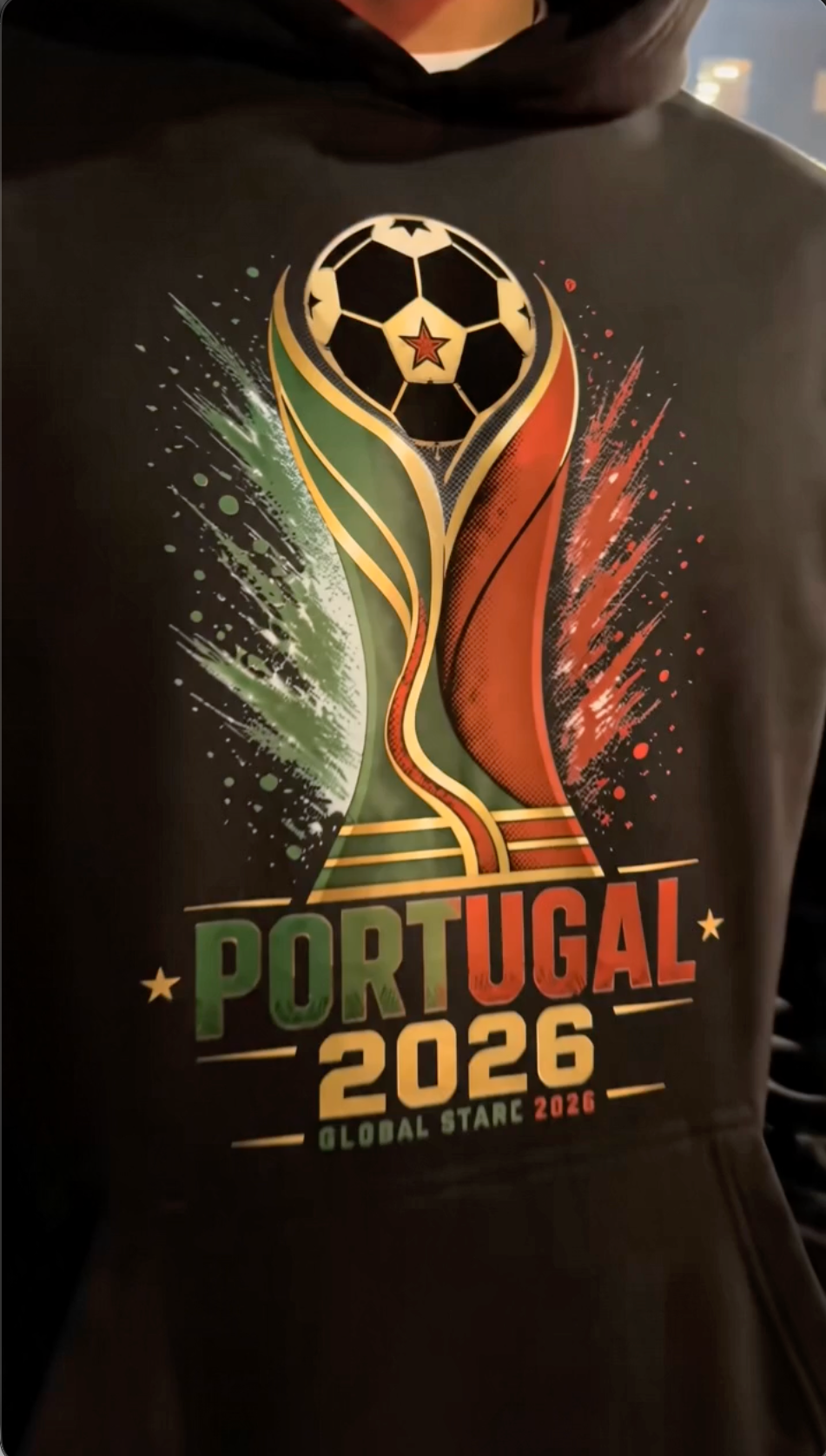 Close-up lifestyle photo of black Portugal 2026 soccer hoodie with Portugal-inspired football trophy graphic