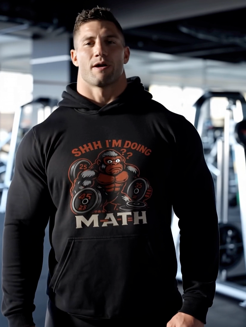Man wearing black hoodie with funny gym math graphic lifting weights fitness hoodie