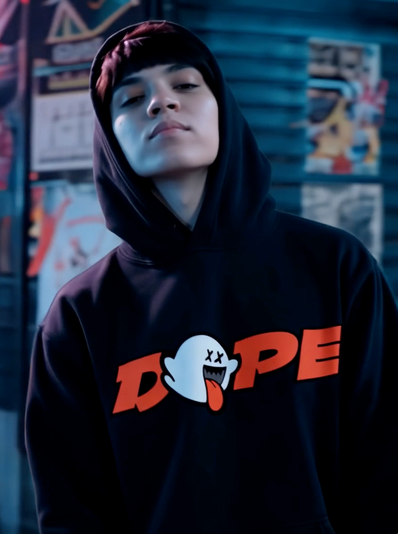 Person wearing black streetwear hoodie with DOPE ghost graphic design in urban setting