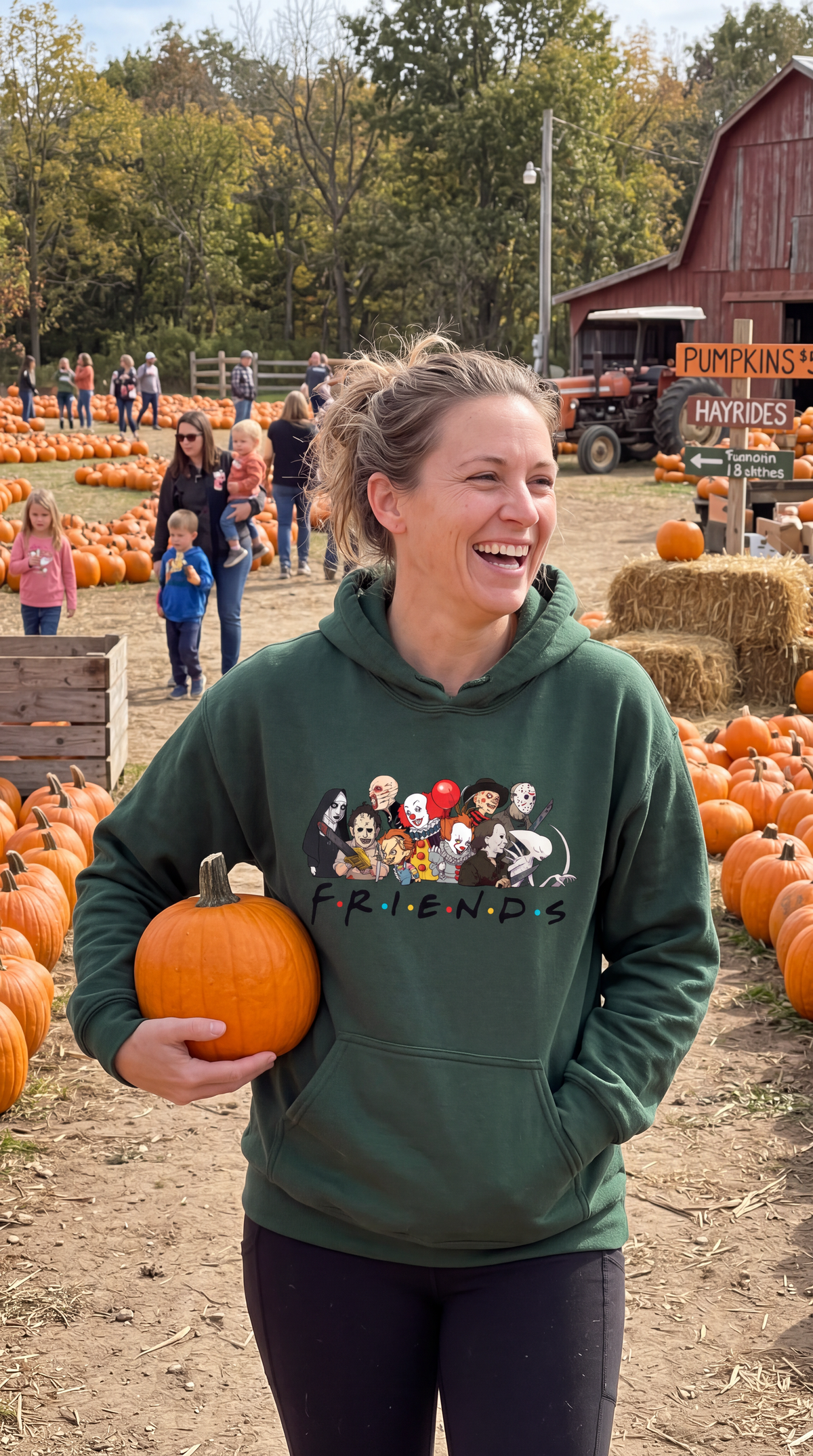 Woman wearing forest green Horror Friends hoodie with classic horror movie graphic