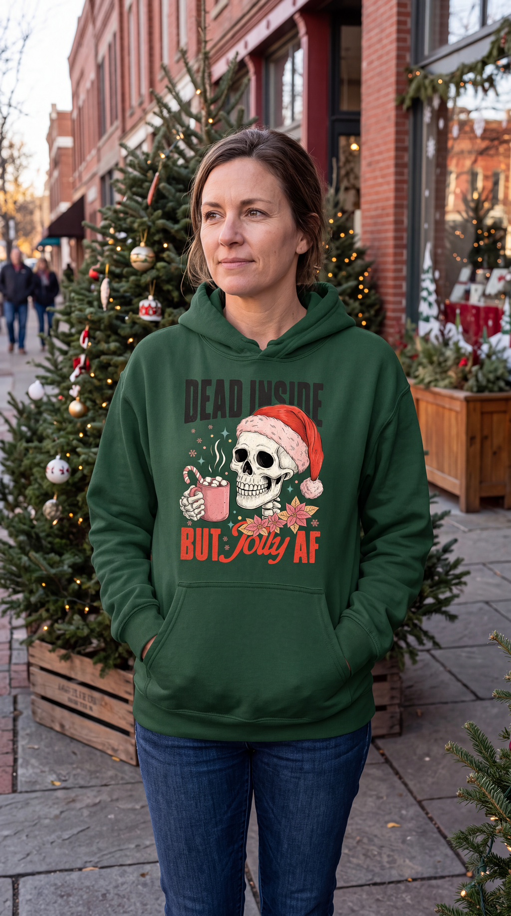 Woman wearing forest green Christmas skeleton hoodie with Dead Inside But Jolly AF design