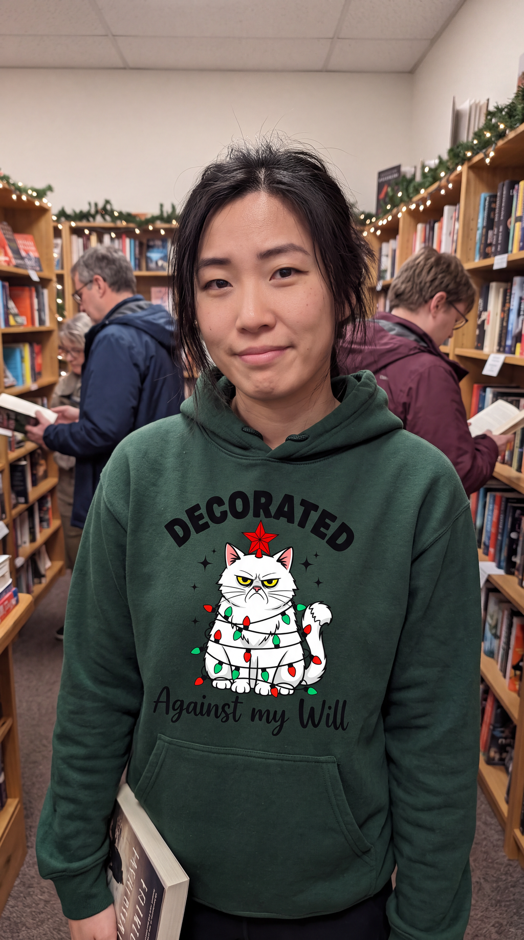 Woman wearing forest green cat Christmas hoodie with Decorated Against My Will design