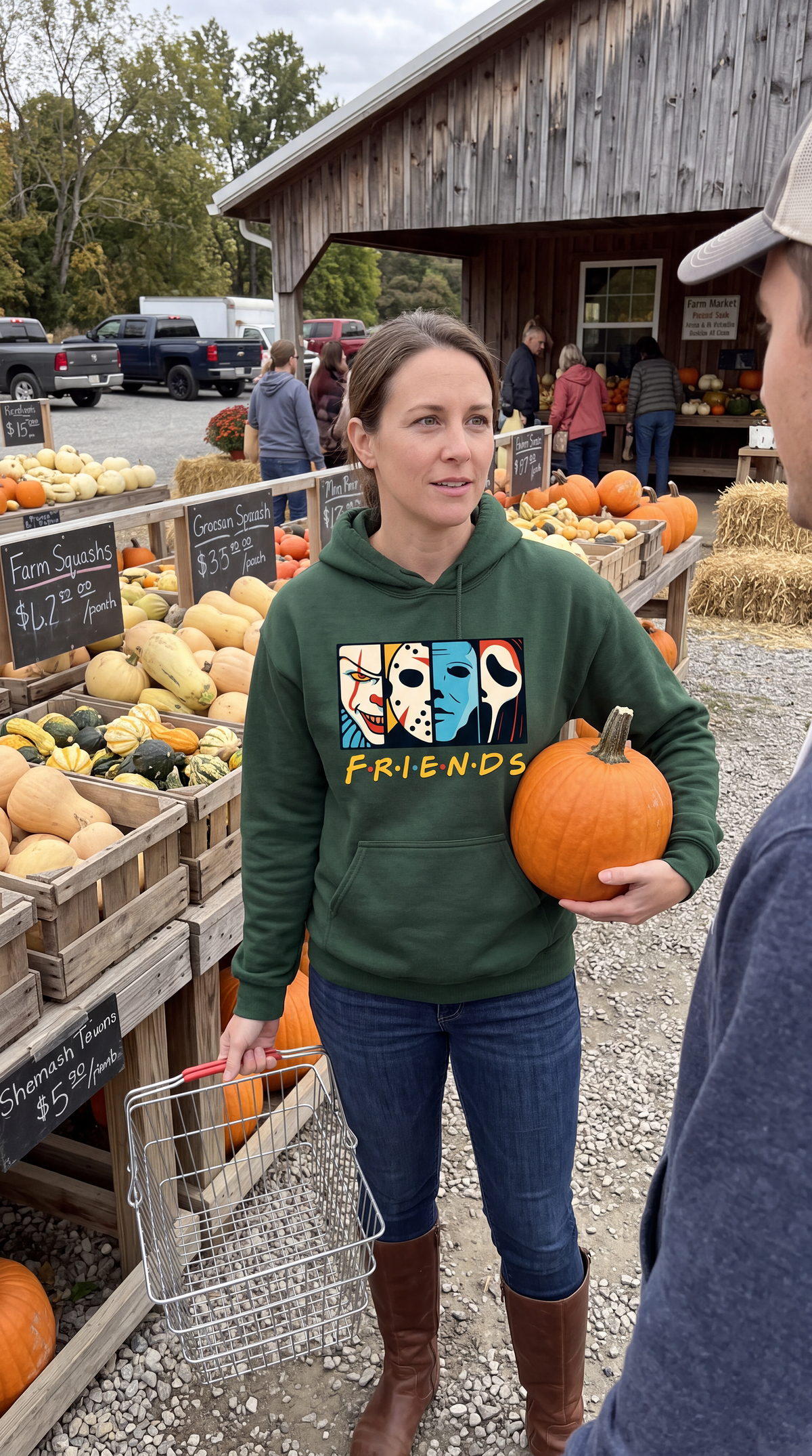 Man wearing forest green Horror Friends hoodie with colorful horror character design.