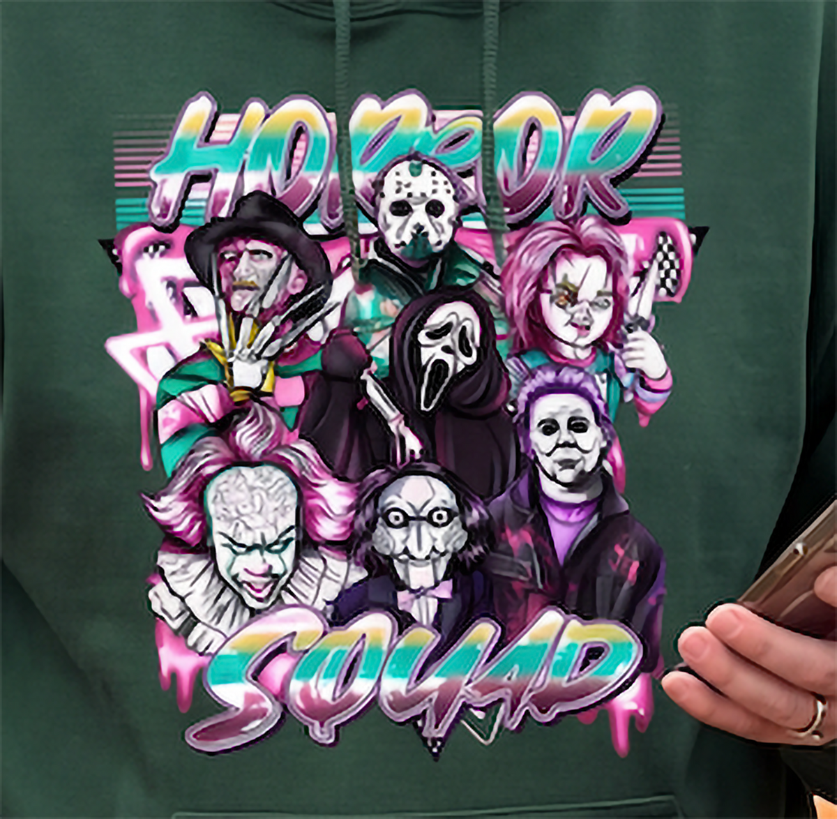 Close-up of forest green Horror Squad Halloween hoodie with classic horror characters