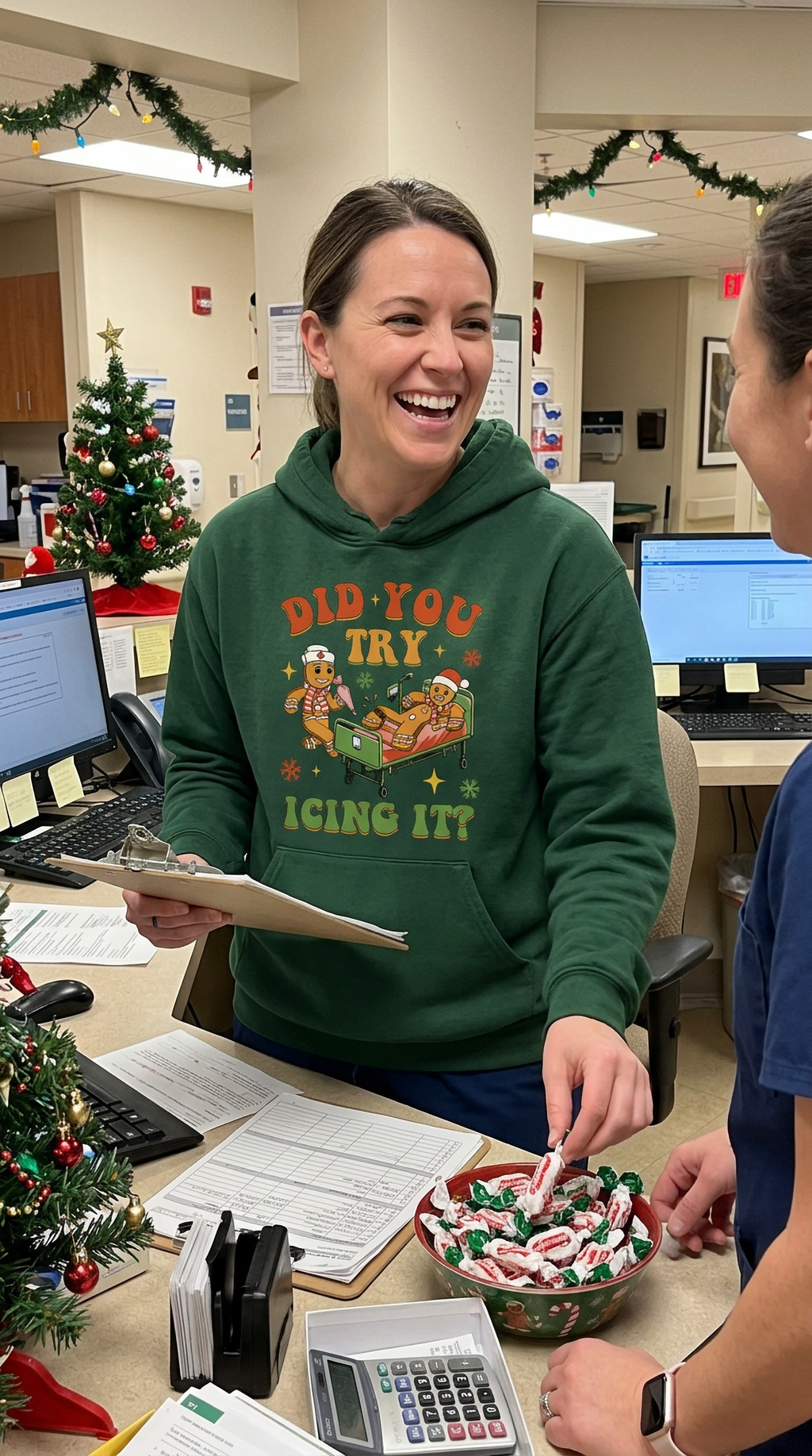 Woman wearing forest green Did You Try Icing It Christmas hoodie in a healthcare setting
