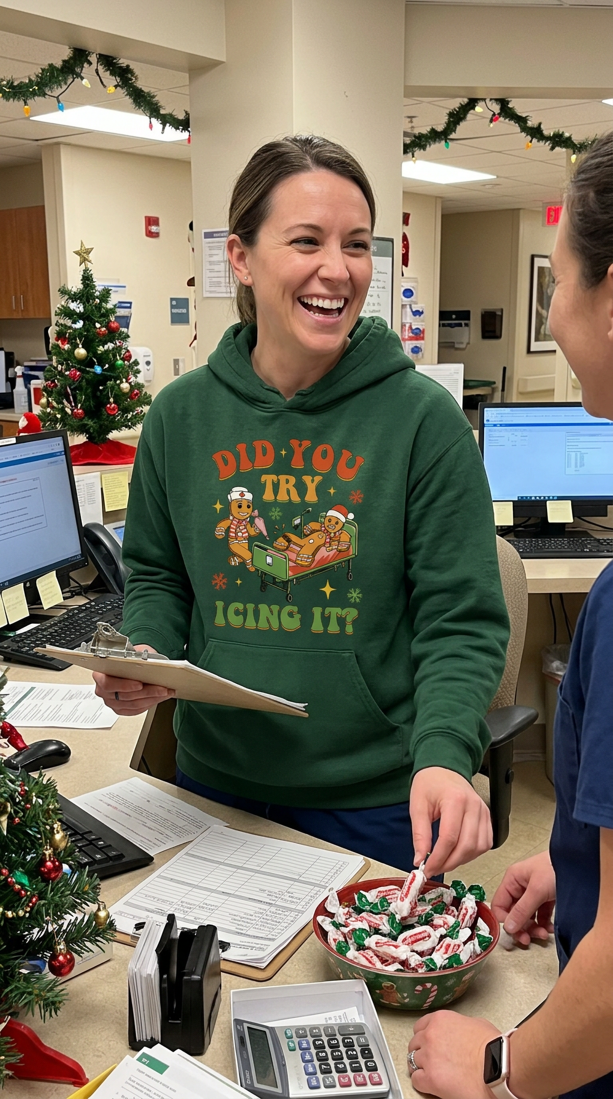 Woman wearing forest green Did You Try Icing It Christmas hoodie in a healthcare setting