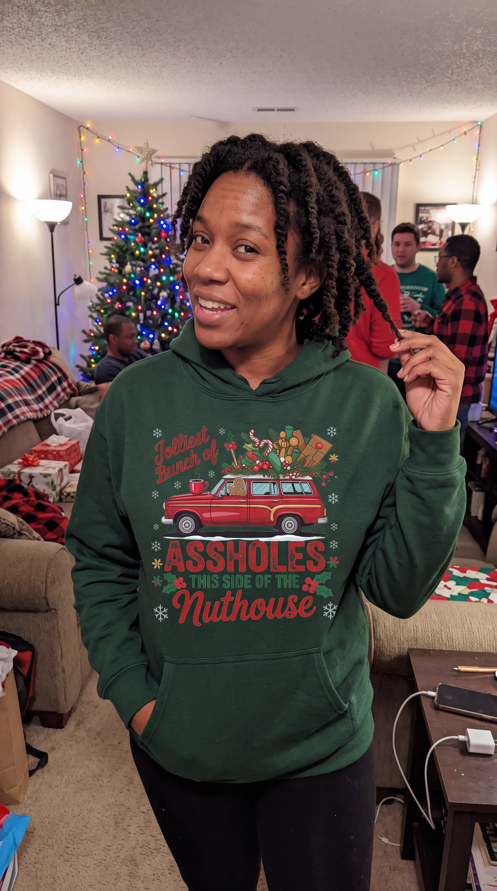 Woman wearing forest green Jolliest Bunch funny family Christmas hoodie