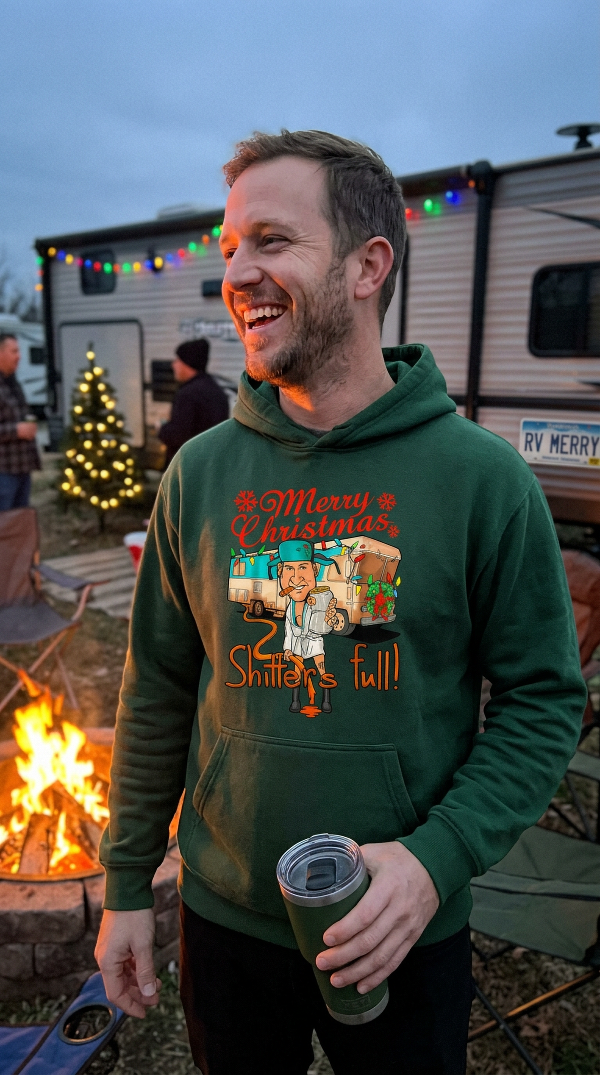 Man wearing forest green Shitter’s Full Cousin Eddie Christmas hoodie outdoors