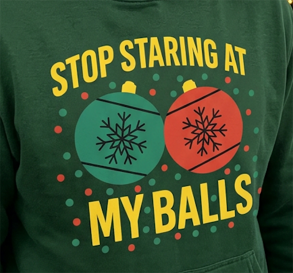 Close-up of Stop Staring at My Balls funny Christmas graphic on forest green hoodie