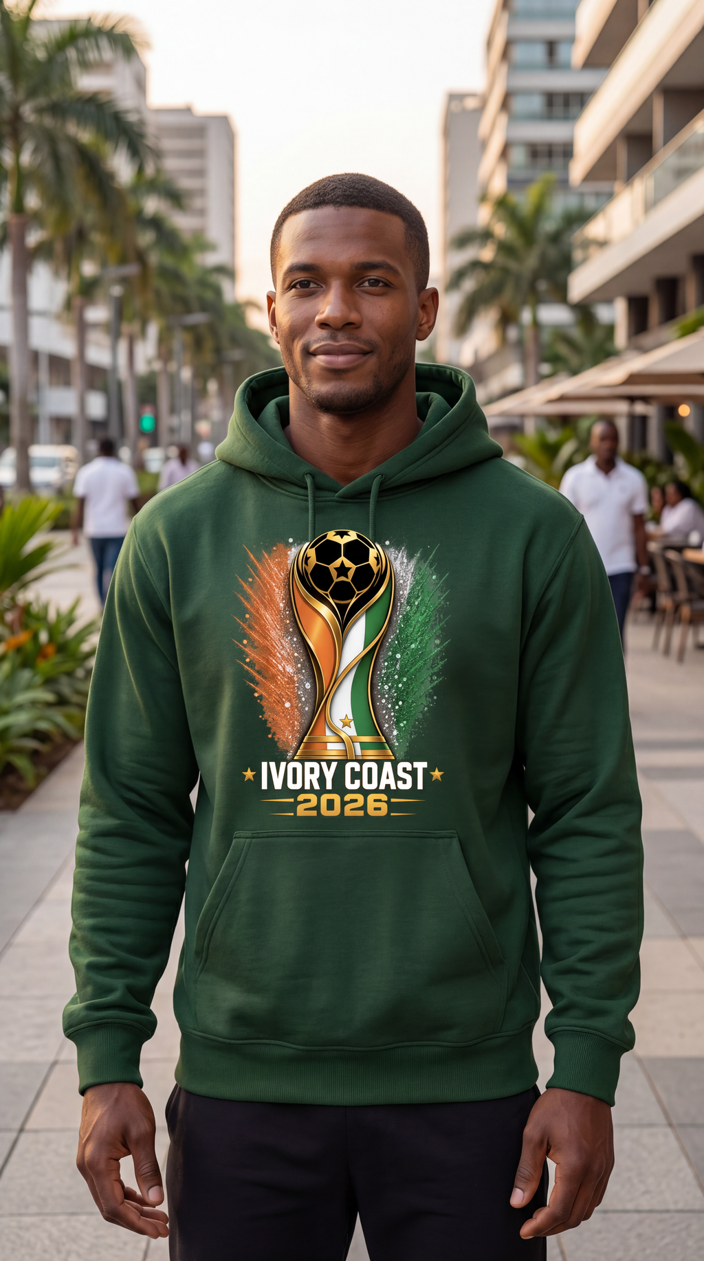Man wearing a green hoodie with Ivory Coast 2026 design in an urban setting