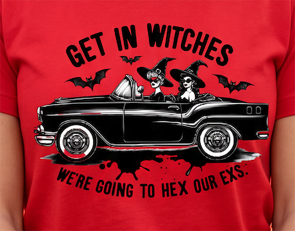 A red short-sleeve t-shirt featuring a graphic of a black vintage convertible with two witches driving it, surrounded by bats and the text 'GET IN WITCHES WE'RE GOING TO HEX OUR EXS.'.