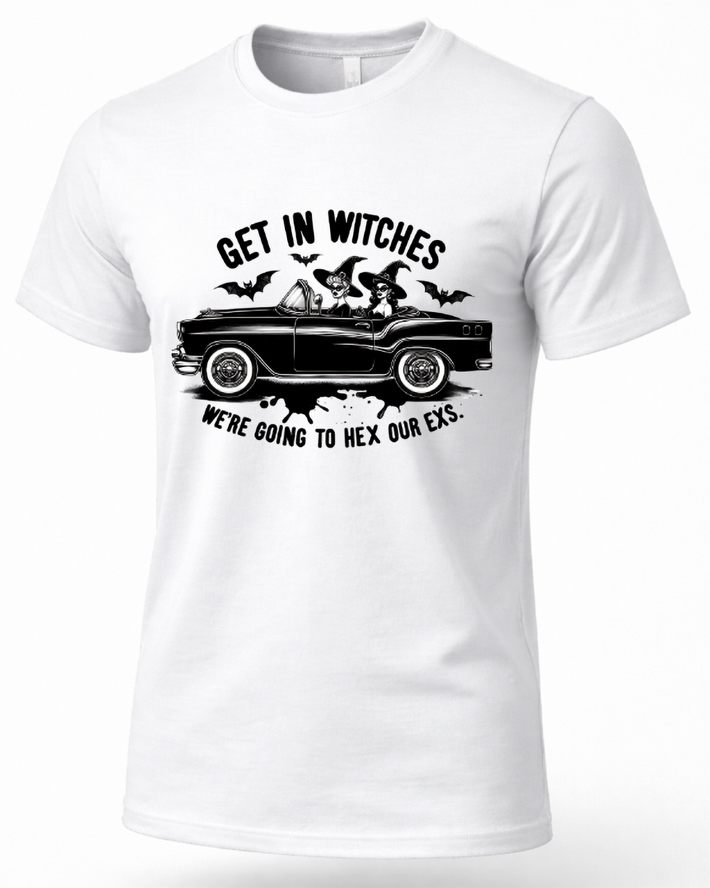 A white short-sleeve crewneck t-shirt with a black graphic print on the front. The graphic features a vintage car with two witches riding in it, surrounded by bats, with the text 'GET IN WITCHES' above and 'WE'RE GOING TO HEX OUR EX.