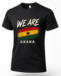 A black short-sleeve crewneck t-shirt featuring a distressed graphic of the Ghana flag with the text 'WE ARE' above and 'GHANA' below in white, shown on a clean white background.