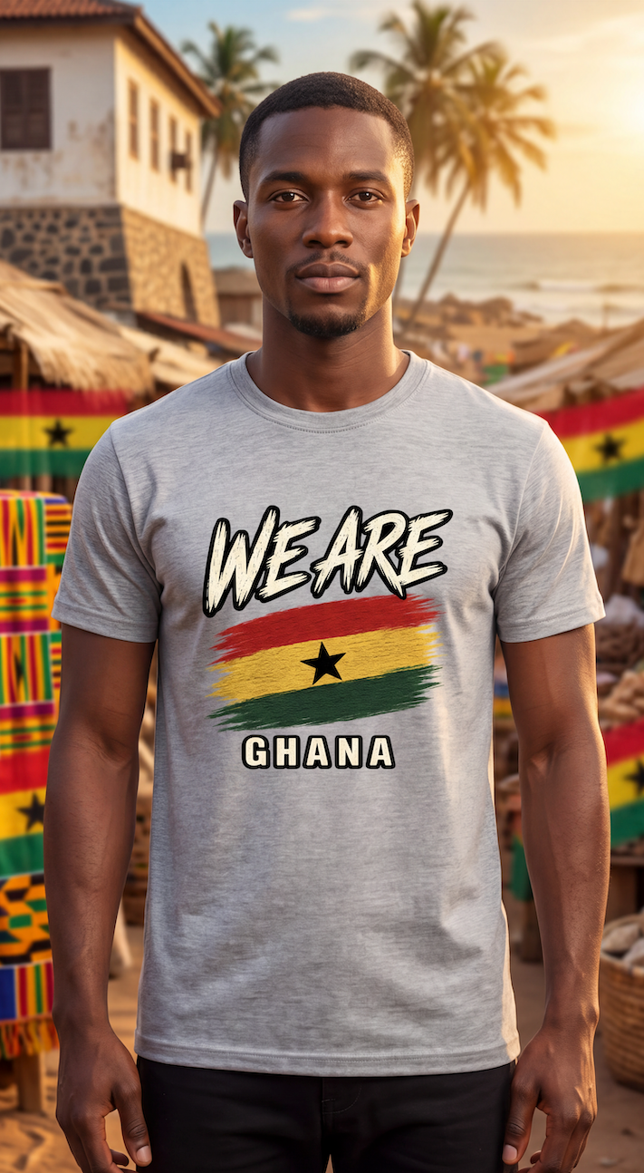 A man wearing a light gray t-shirt with a 'WE ARE GHANA' graphic featuring the Ghana flag, standing in front of a beach and market background.