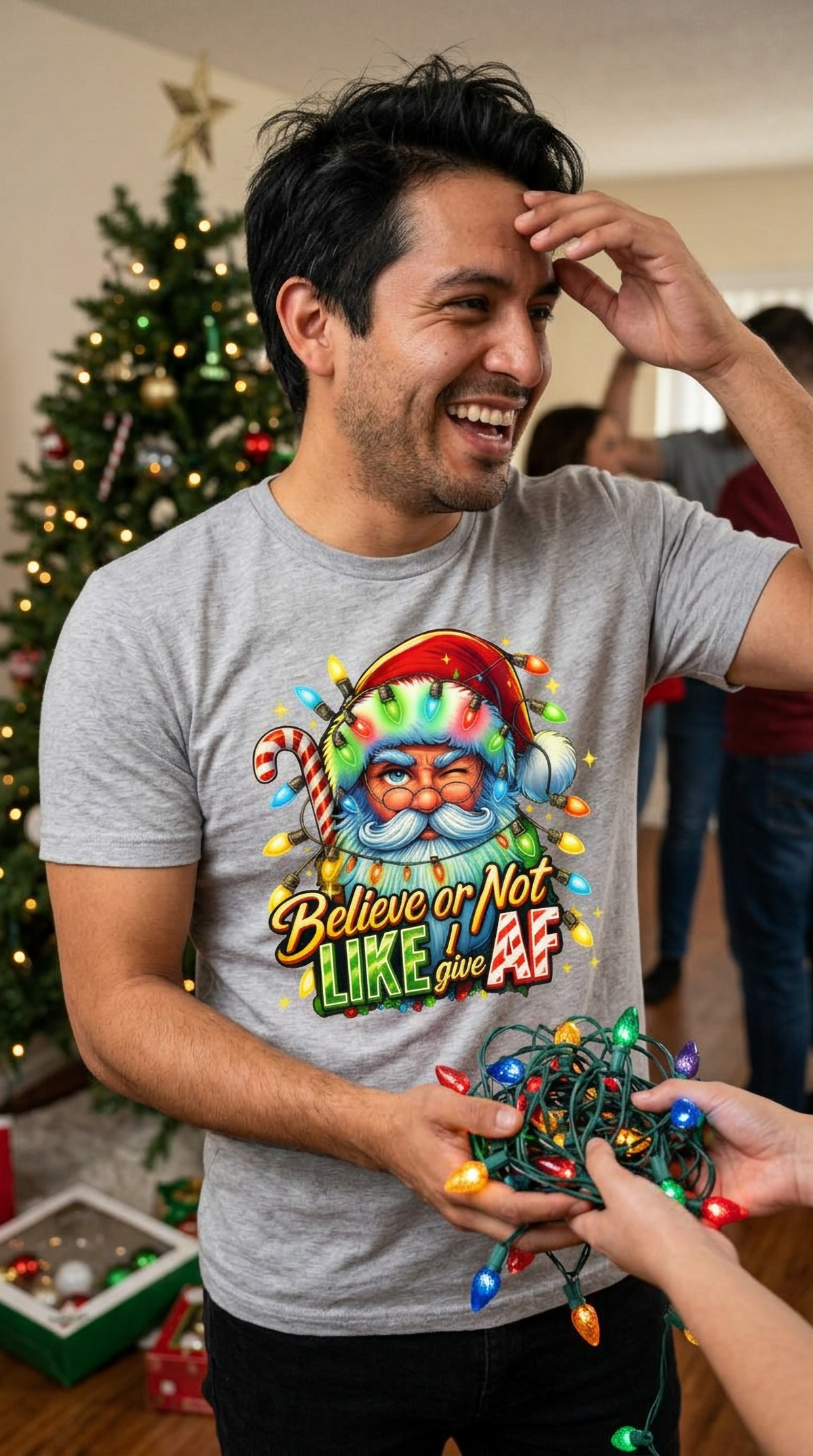 Lifestyle – Heather Gray: Man wearing a heather gray funny Santa Christmas graphic tee while celebrating at an indoor holiday gathering.