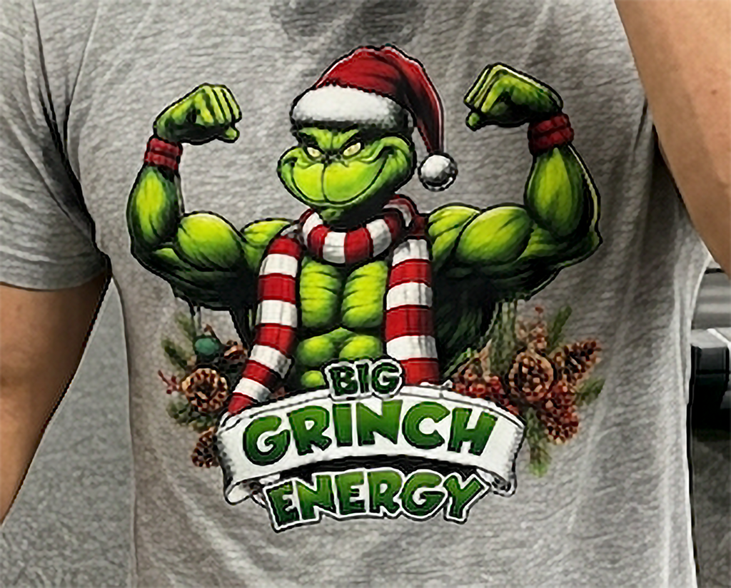 Detailed close-up of Big Grinch Energy Christmas artwork on heather gray t-shirt featuring muscular Grinch and holiday greenery.
