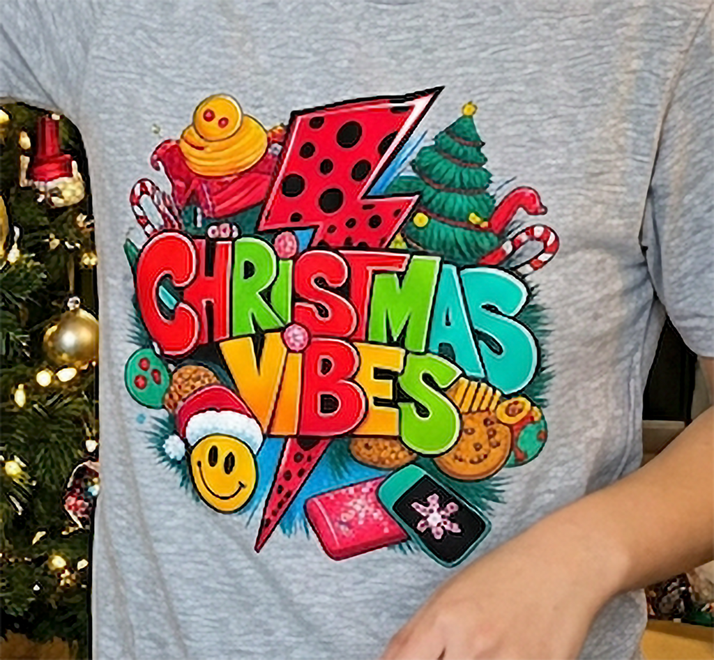 Heather Gray Design Close-Up: Close-up of colorful Christmas Vibes holiday design printed on a heather gray unisex graphic t-shirt.