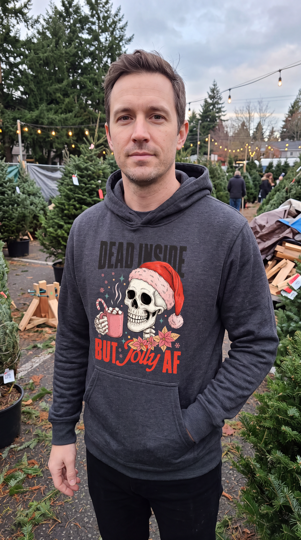 Man wearing gray Christmas skeleton hoodie with Dead Inside But Jolly AF design