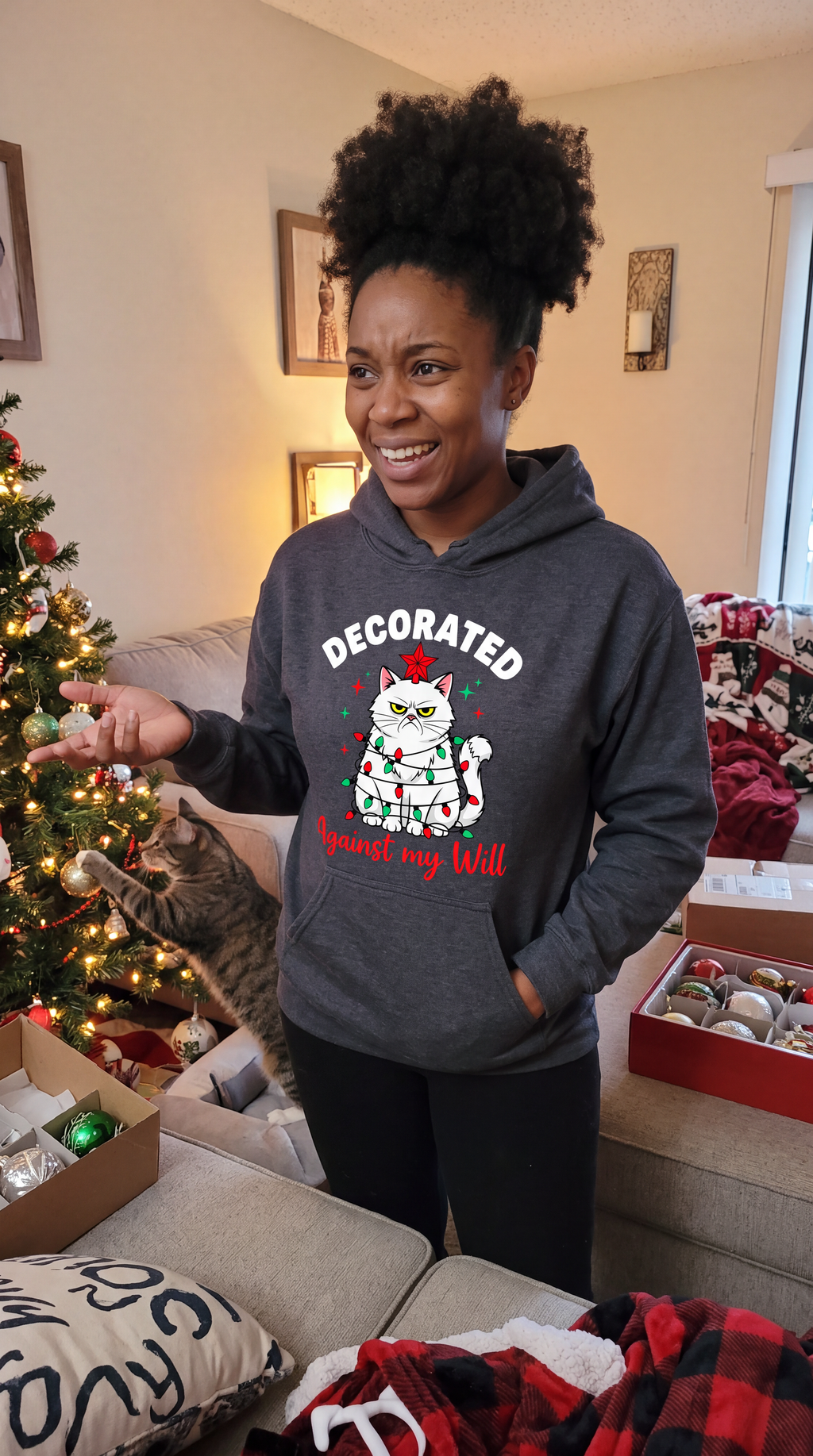 Woman wearing gray funny cat Christmas hoodie with grumpy holiday cat design