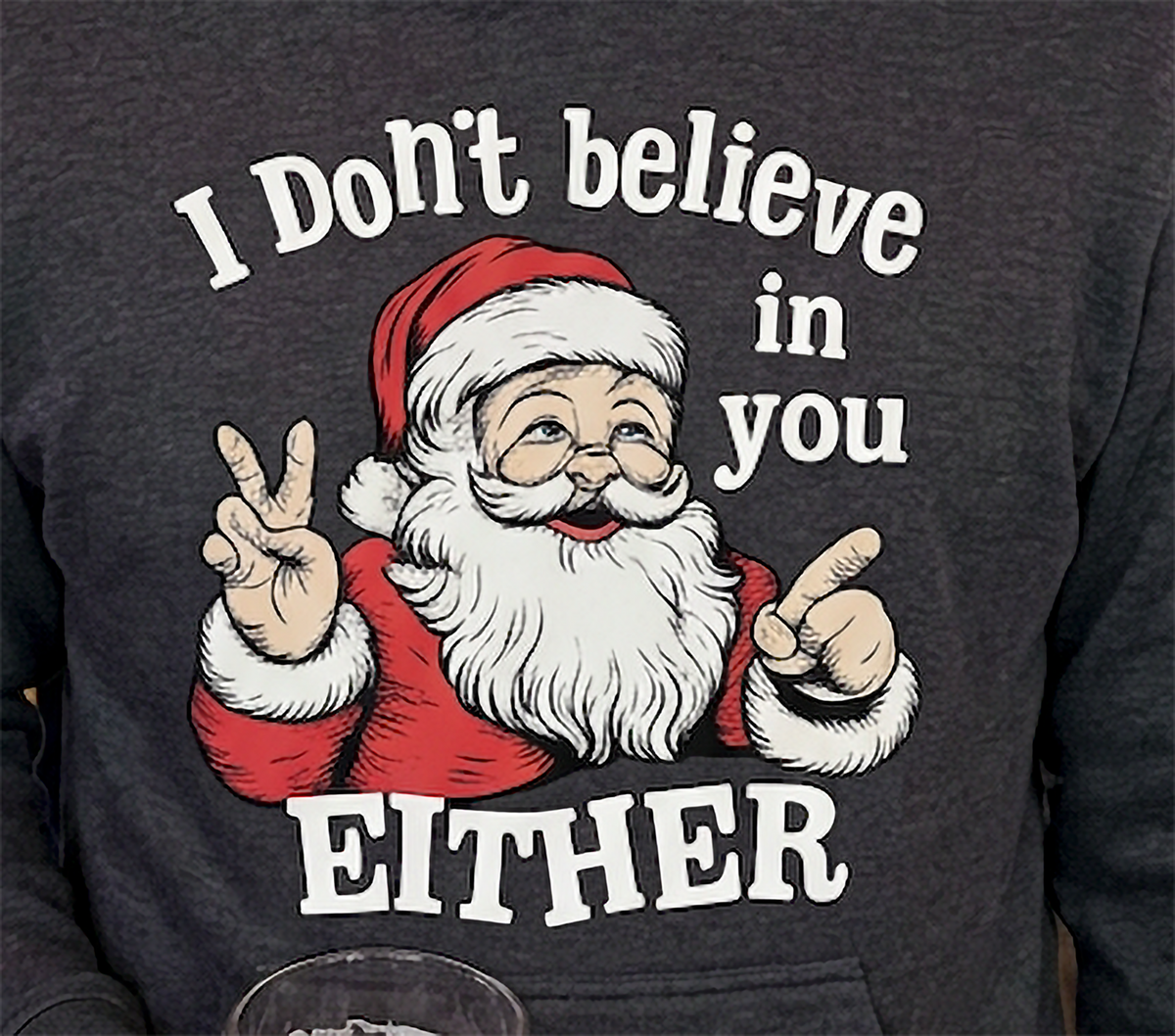 Close-up of I Don’t Believe in You Either Santa graphic on gray Christmas hoodie