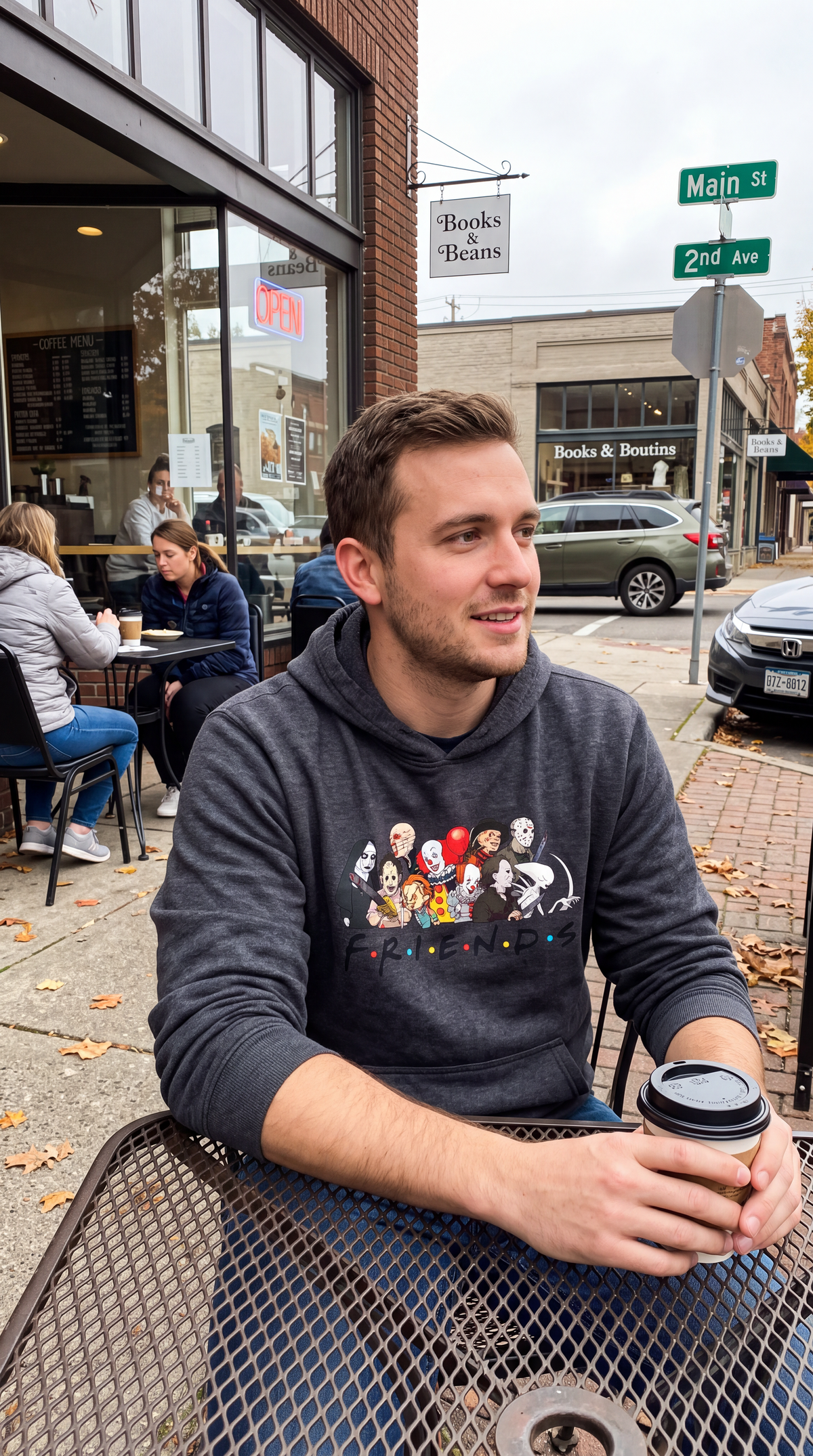 Man wearing dark gray Horror Friends hoodie with classic horror movie graphic