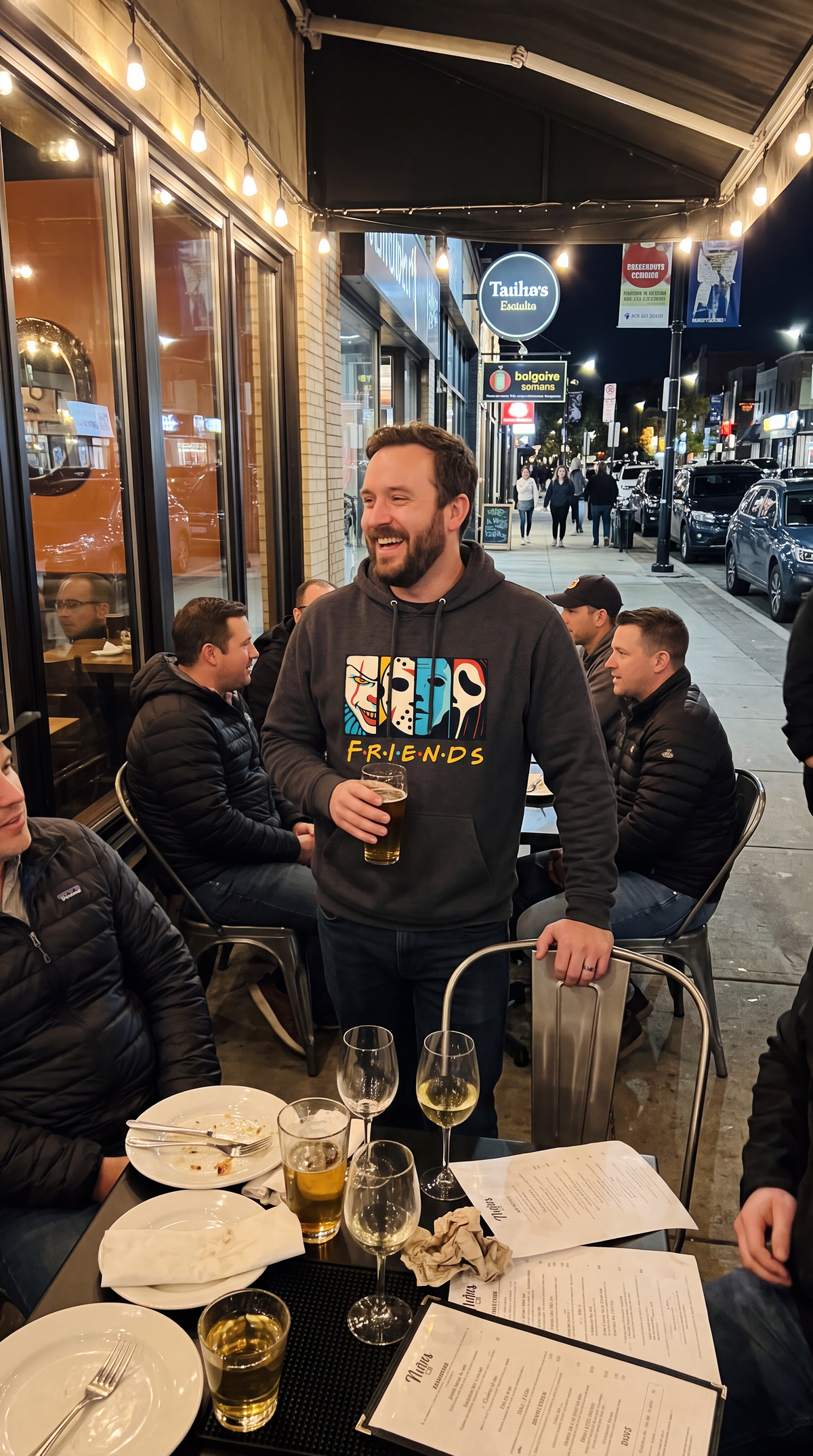 Man wearing gray Horror Friends hoodie featuring colorful horror character graphic.